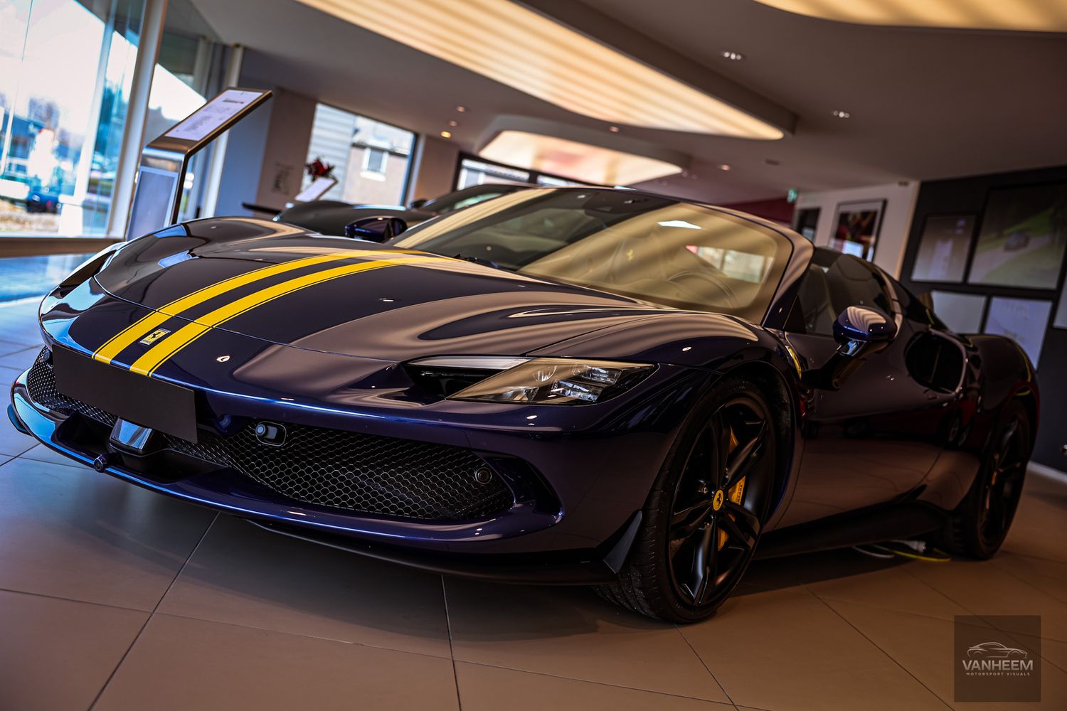 Luxury sports cars with racing livery displayed in an elegant indoor showroom.