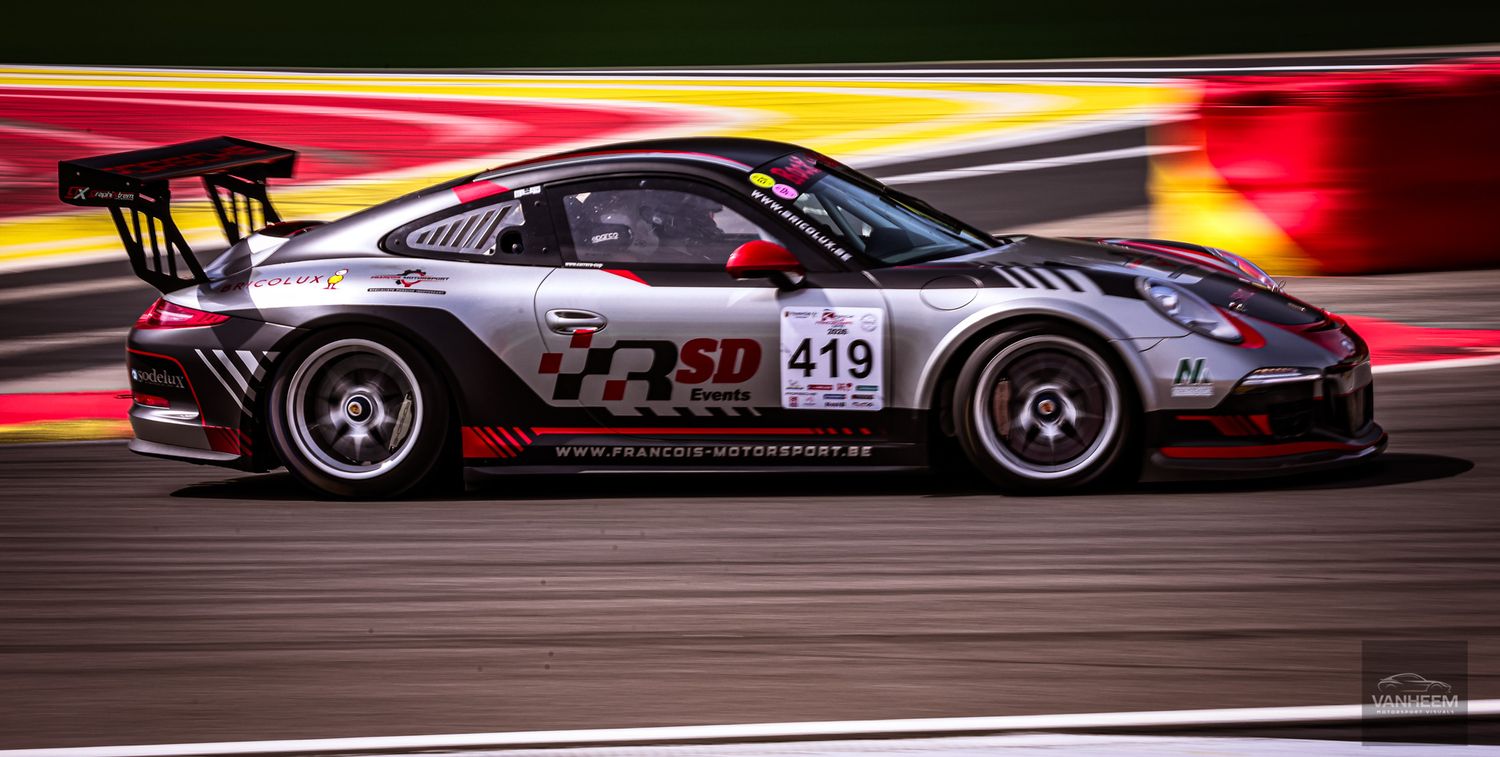 Porsche 911 GT3 Cup race car number 419 with SD livery speeding on track at a motorsport circuit.