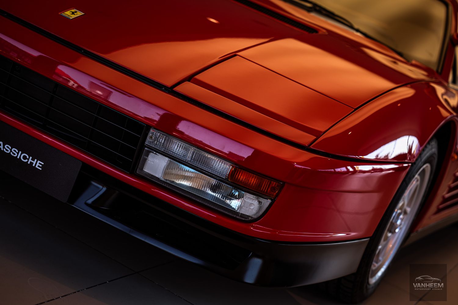 Detail shots of a classic red Ferrari's front end and headlight assembly.