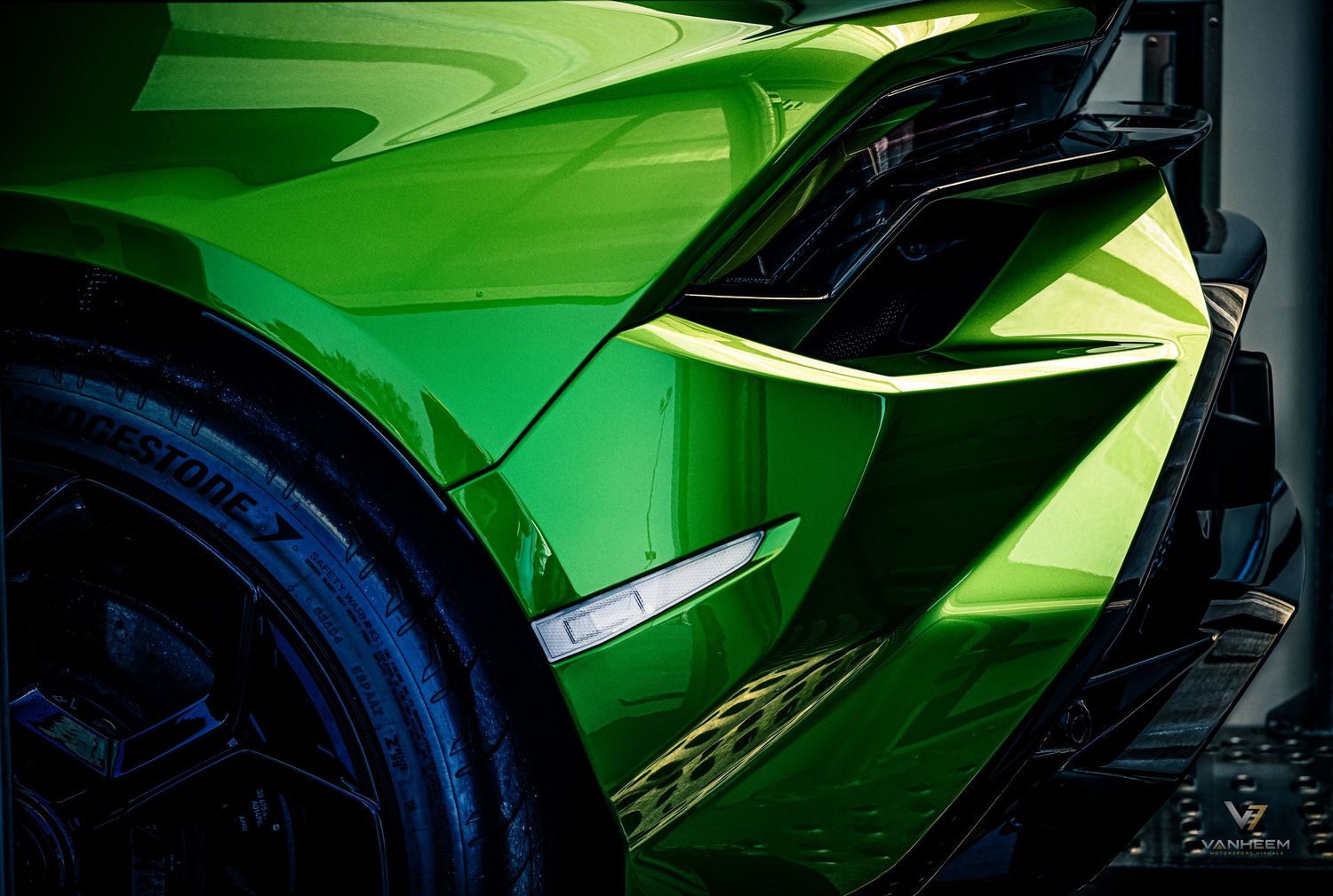 Close-up of a vibrant green Lamborghini Aventador showcasing its sharp angular bodywork and sleek aerodynamic design.