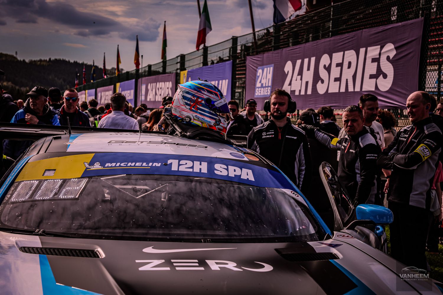Racing driver in helmet beside ZERUJ GT car at 24H Series 12H Spa endurance race event.
