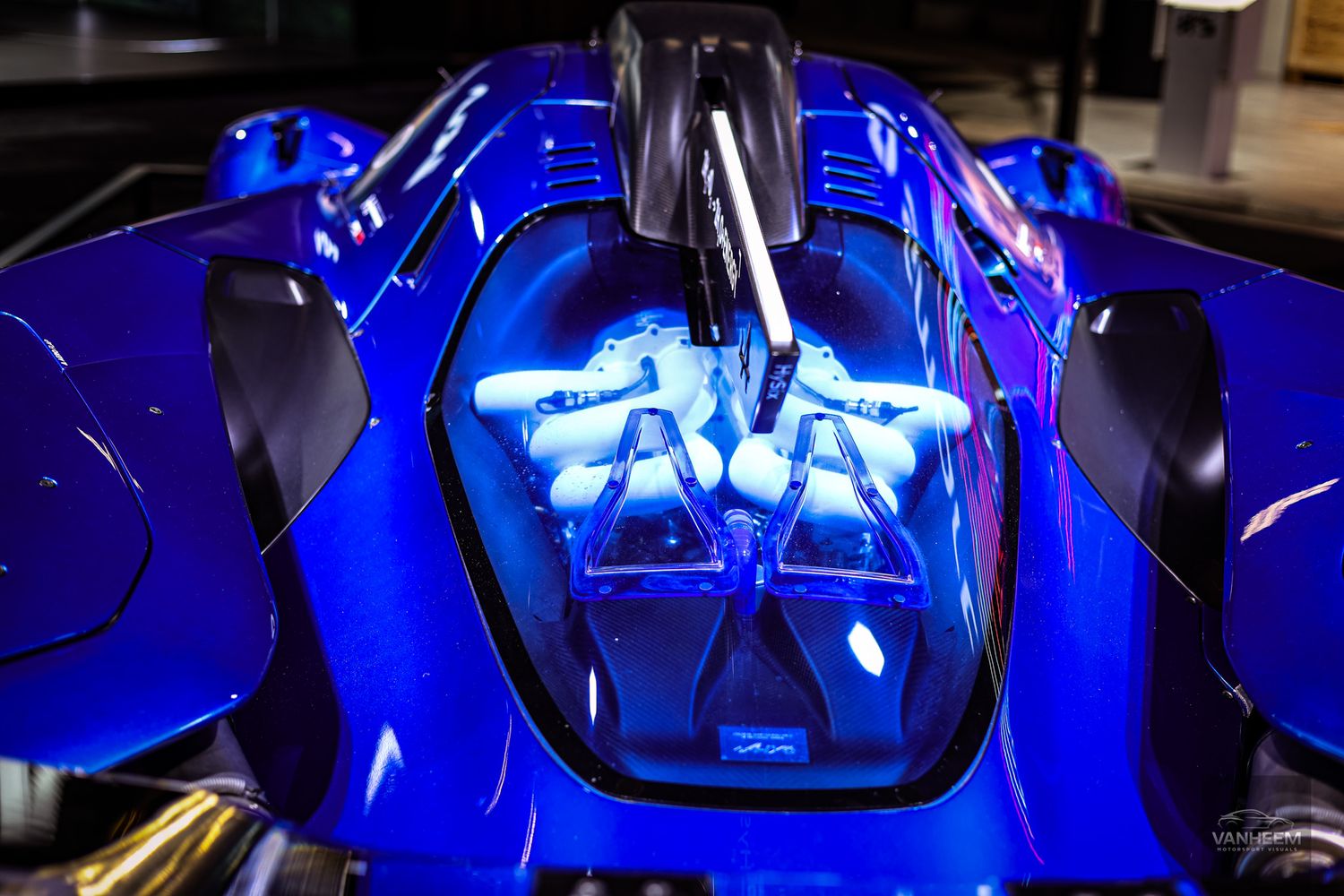 Close-up detail shots of a blue Ferrari SF90 Stradale showcasing its sleek design elements and bodywork.