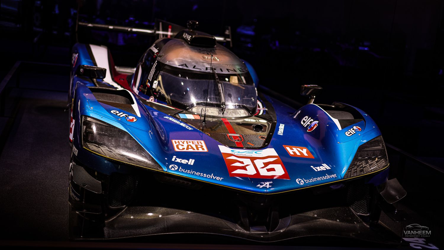 Close-up shots of a blue and orange racing car showing various angles and details of its aerodynamic body design.