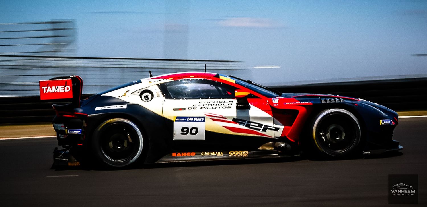 Race car #90 with red, white, and black livery speeding on track during a motorsport competition.