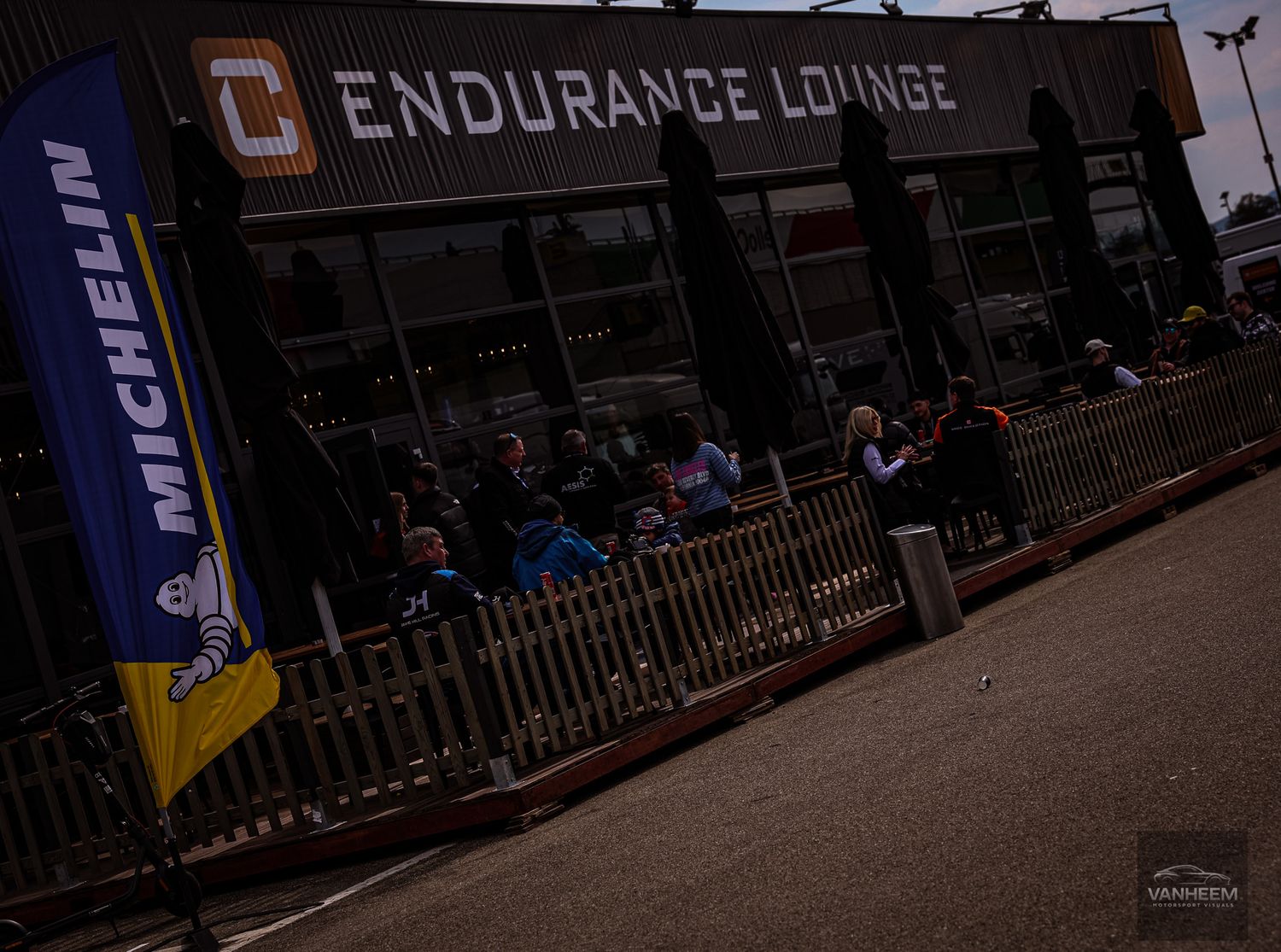 A dark outdoor scene shows multiple banners with 'Endurance Lounge' text visible in low lighting conditions.