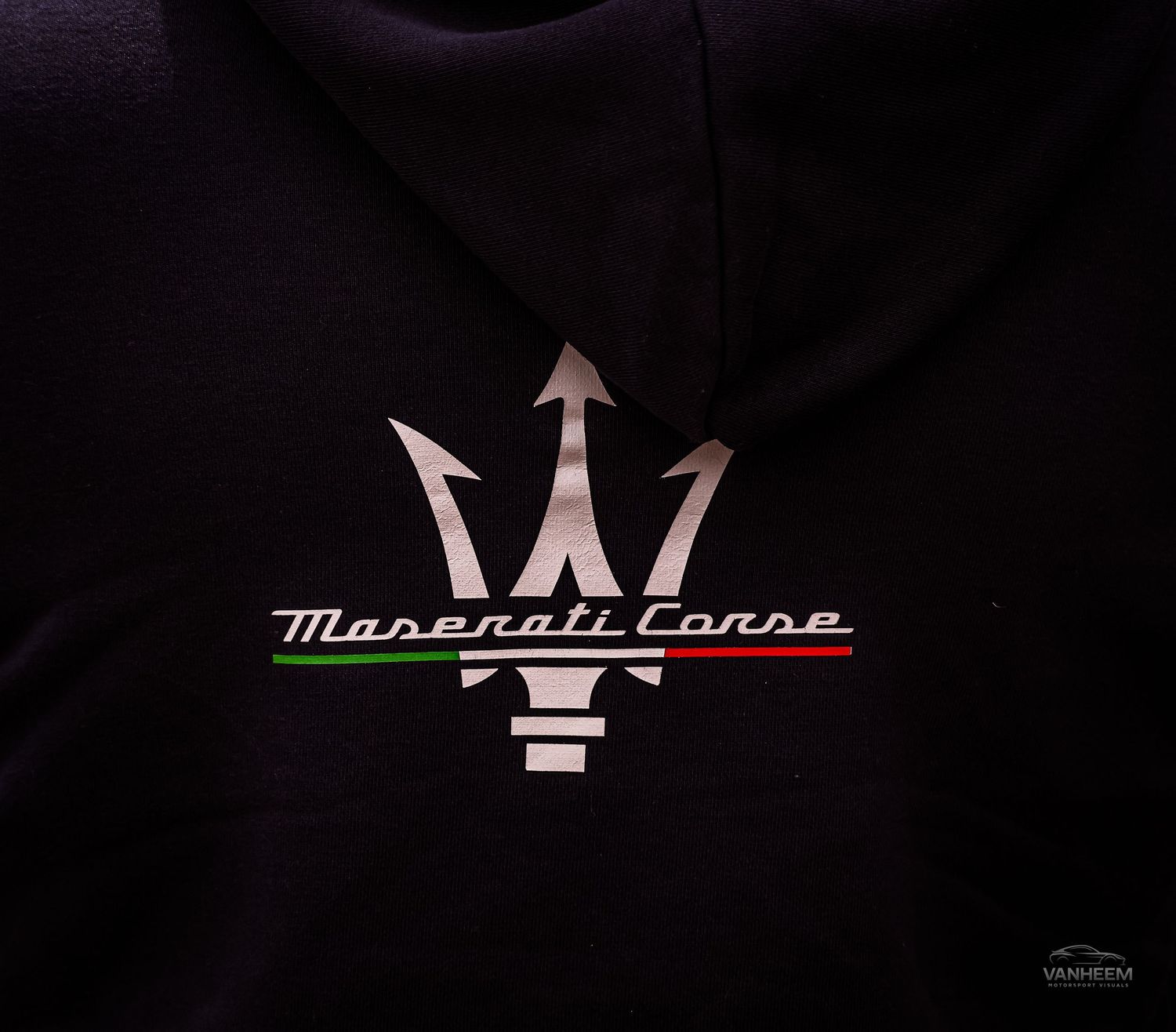 Black Maserati Corse hoodie featuring the iconic silver trident logo with Italian flag colors on the script lettering.