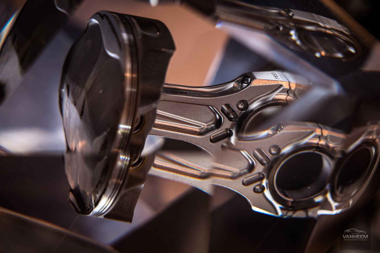Abstract close-up shots of chrome and metal Ferrari engine components.