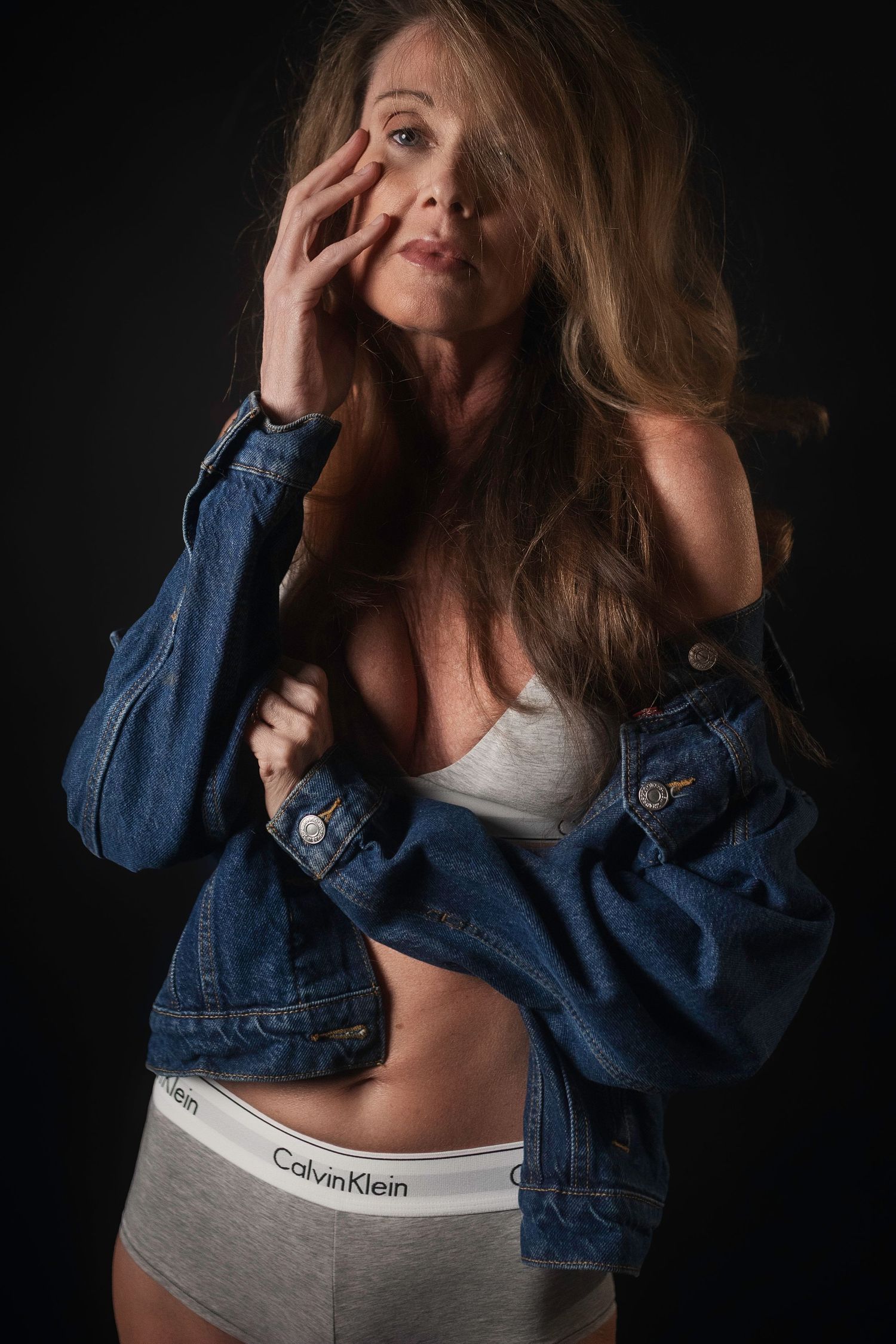Boudoir portrait of a woman in dramatic light, Lock & Key Photography DFW Texas.