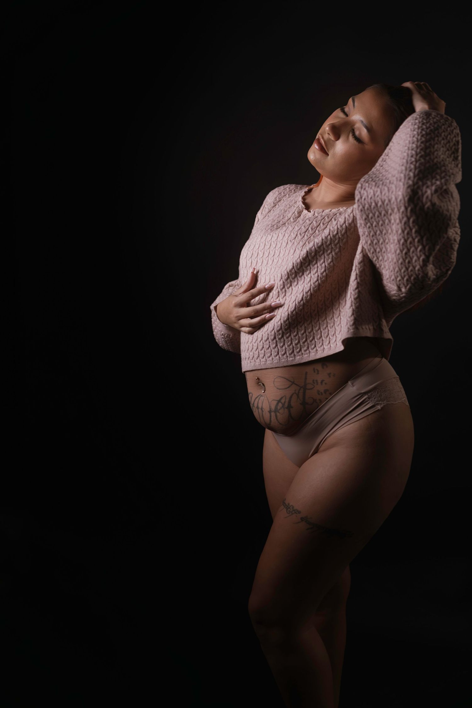 Artistic boudoir portrait with hands framing face, dark background, Fort Worth boudoir studio.