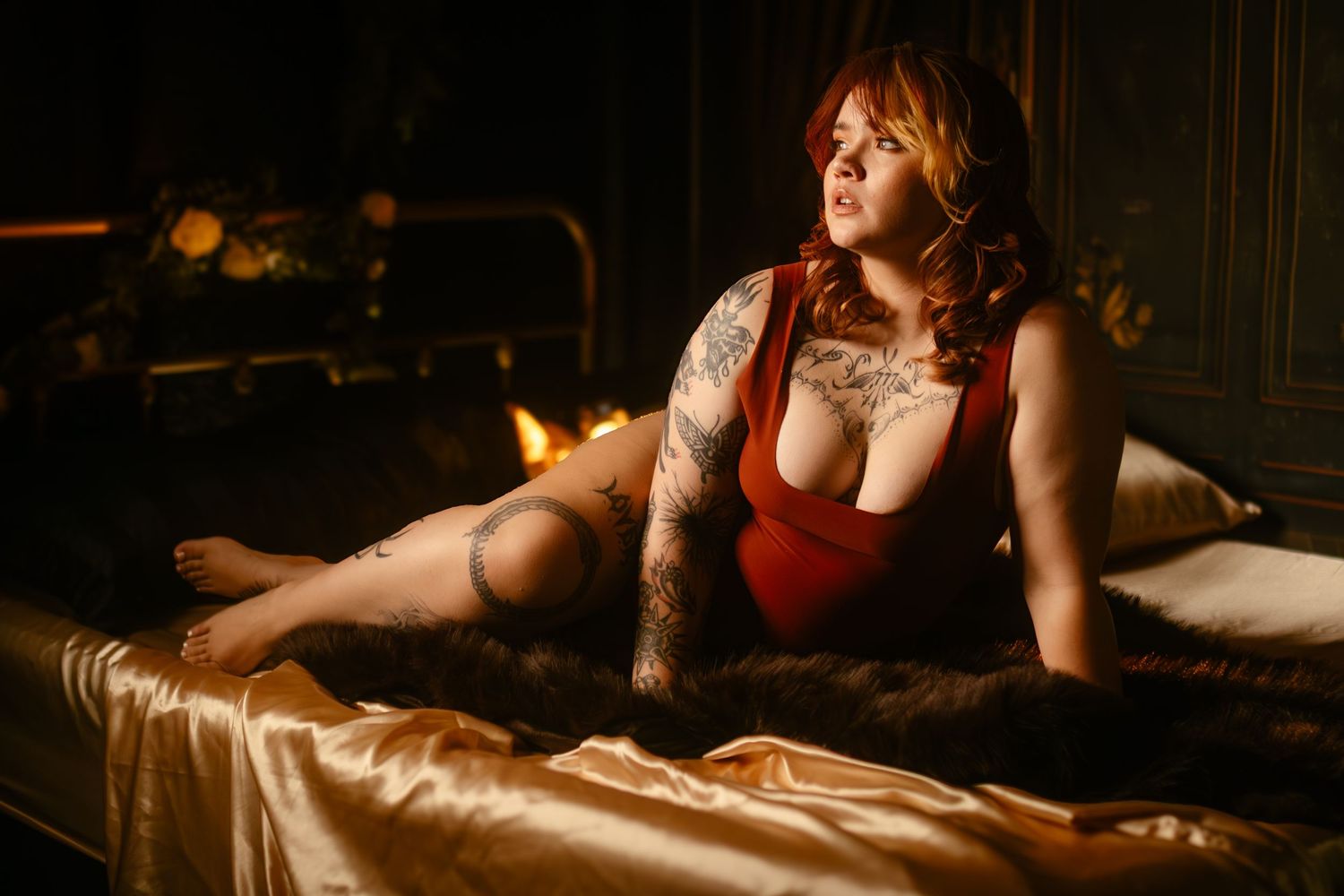 Fort Worth boudoir session in Lock & Key's dark studio with moody light, red lingerie, and gold accents.