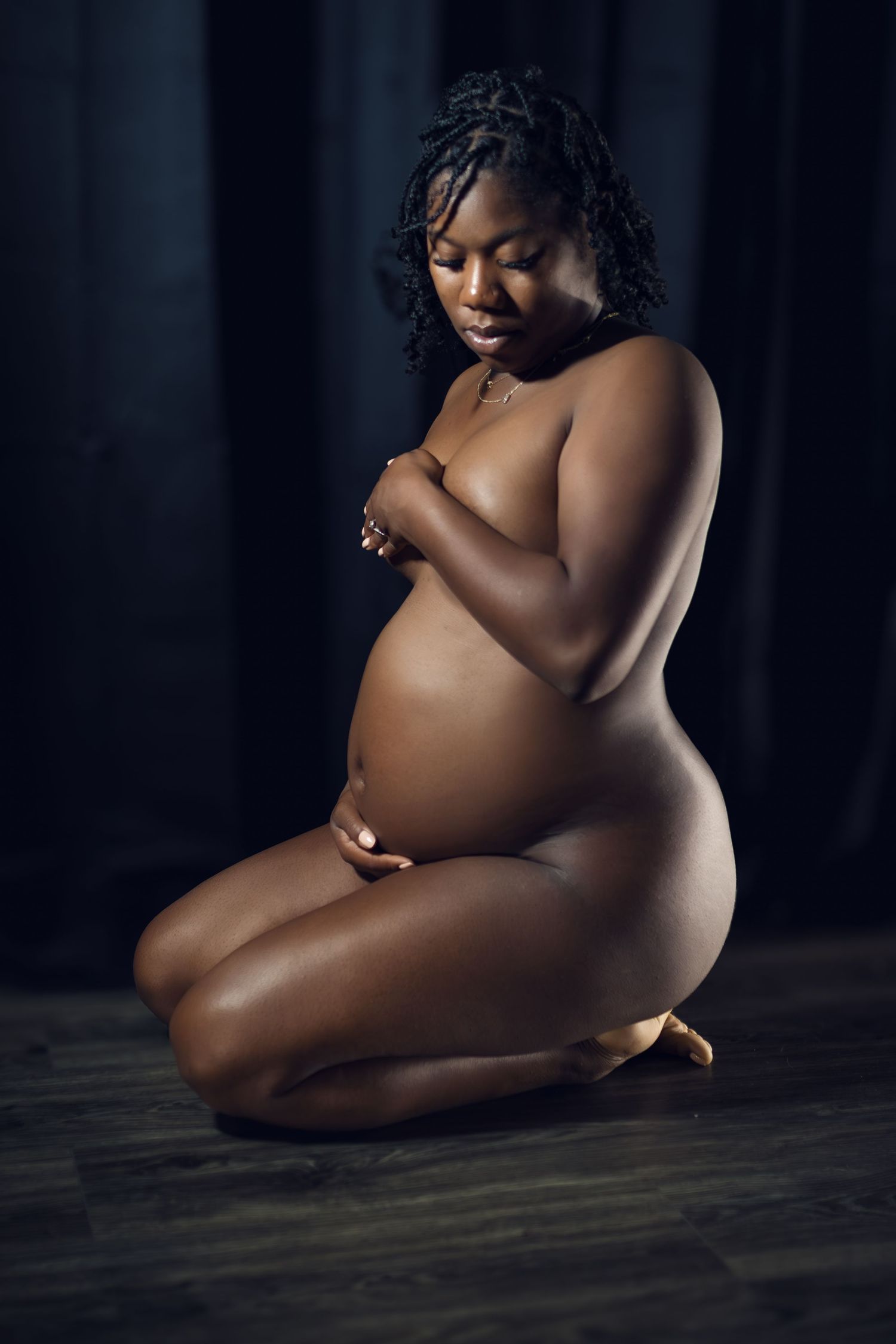Embracing beauty and strength in a Fort Worth maternity boudoir session, celebrating motherhood in an inclusive studio.