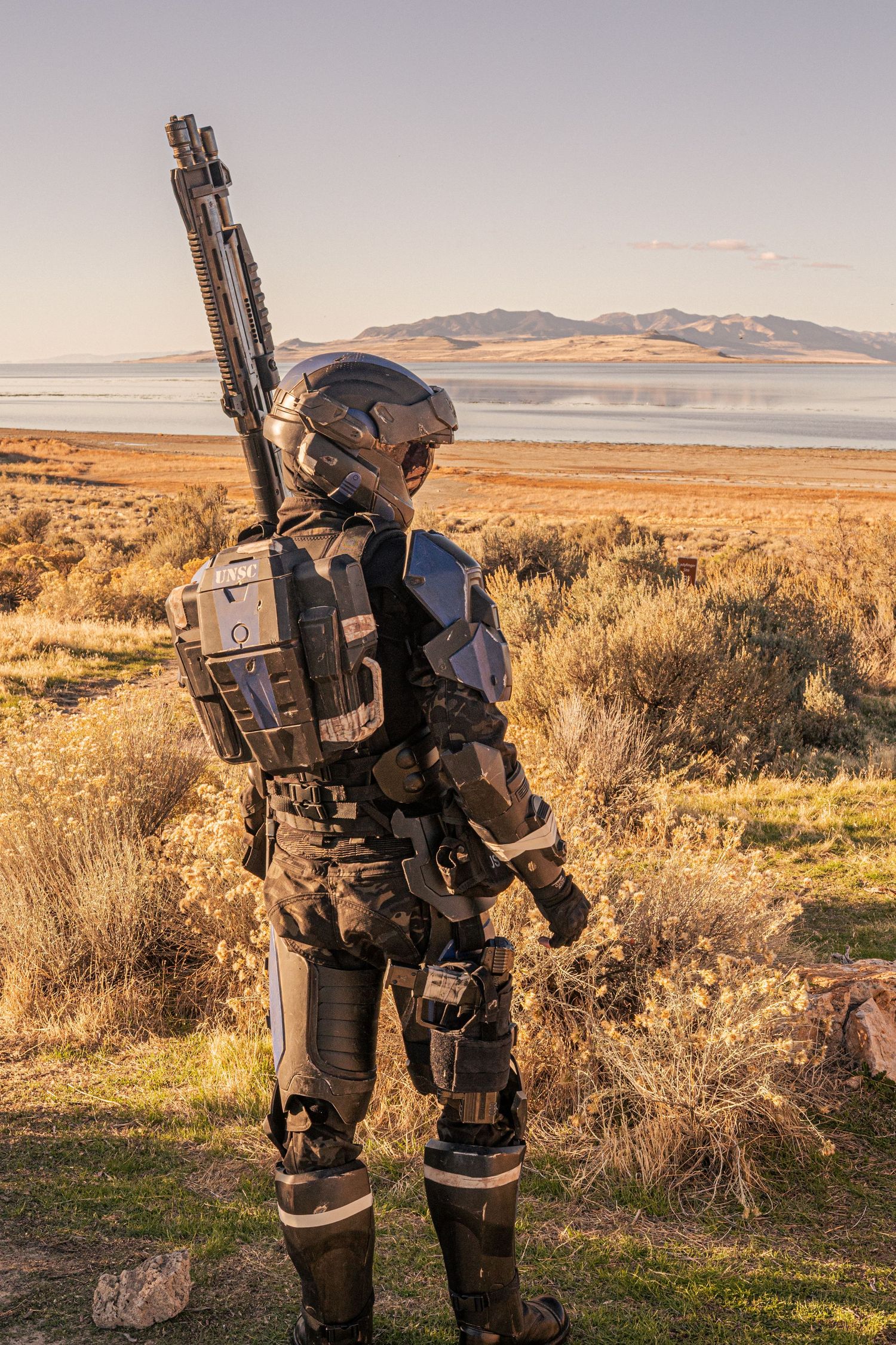 Futuristic soldier cosplay armor with sniper rifle overlooking Great Salt Lake.