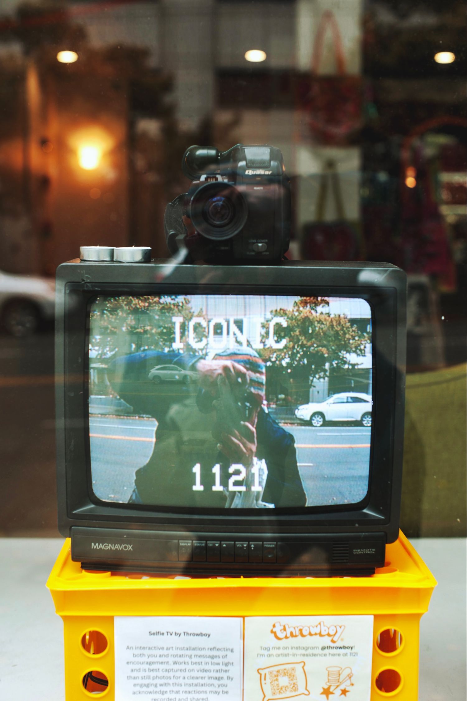Vintage Magnavox CRT TV displaying ICONIC 1121 text with camera on top.