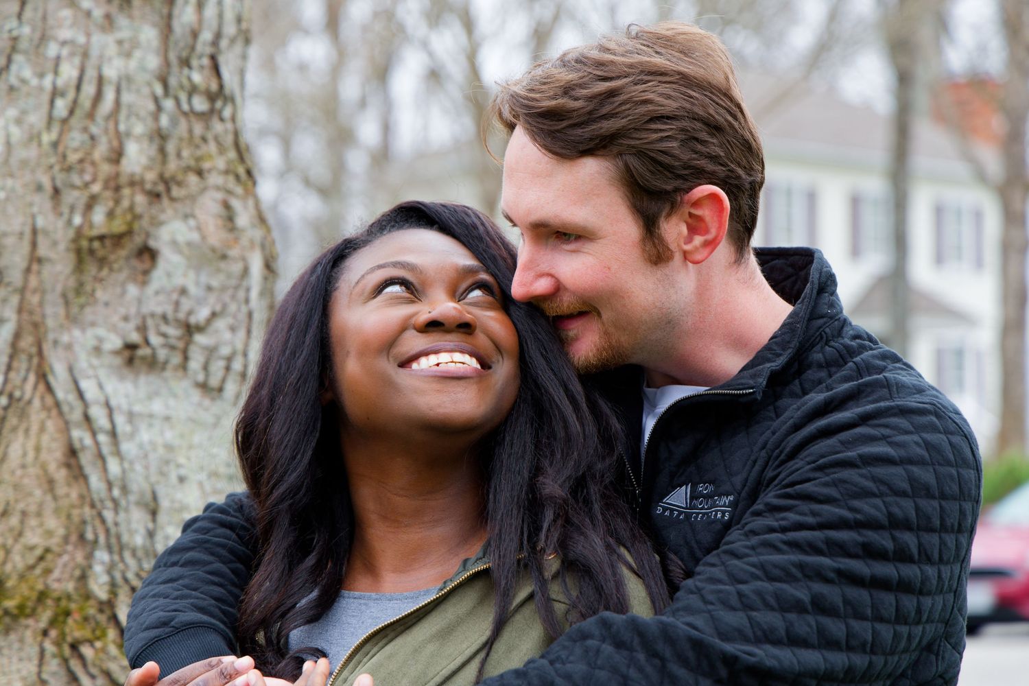 A happy couple shares a tender moment together outdoors near a tree on a winter day. Couples photo, Midlothian, Virginia