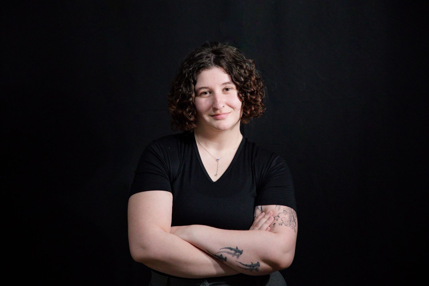 Studio portrait against black background showing confident pose. Headshot in professional studio, Chesterfield, Virginia, RVA, Richmond