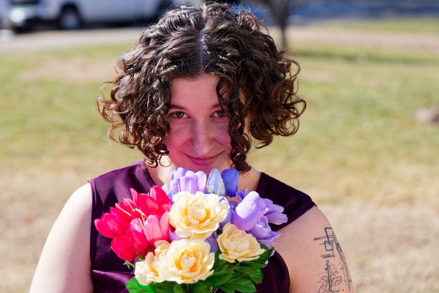 A person holds a colorful bouquet of roses with pink, yellow and purple blooms. Valentines event, Richmond RVA, Midlothian, Virginia