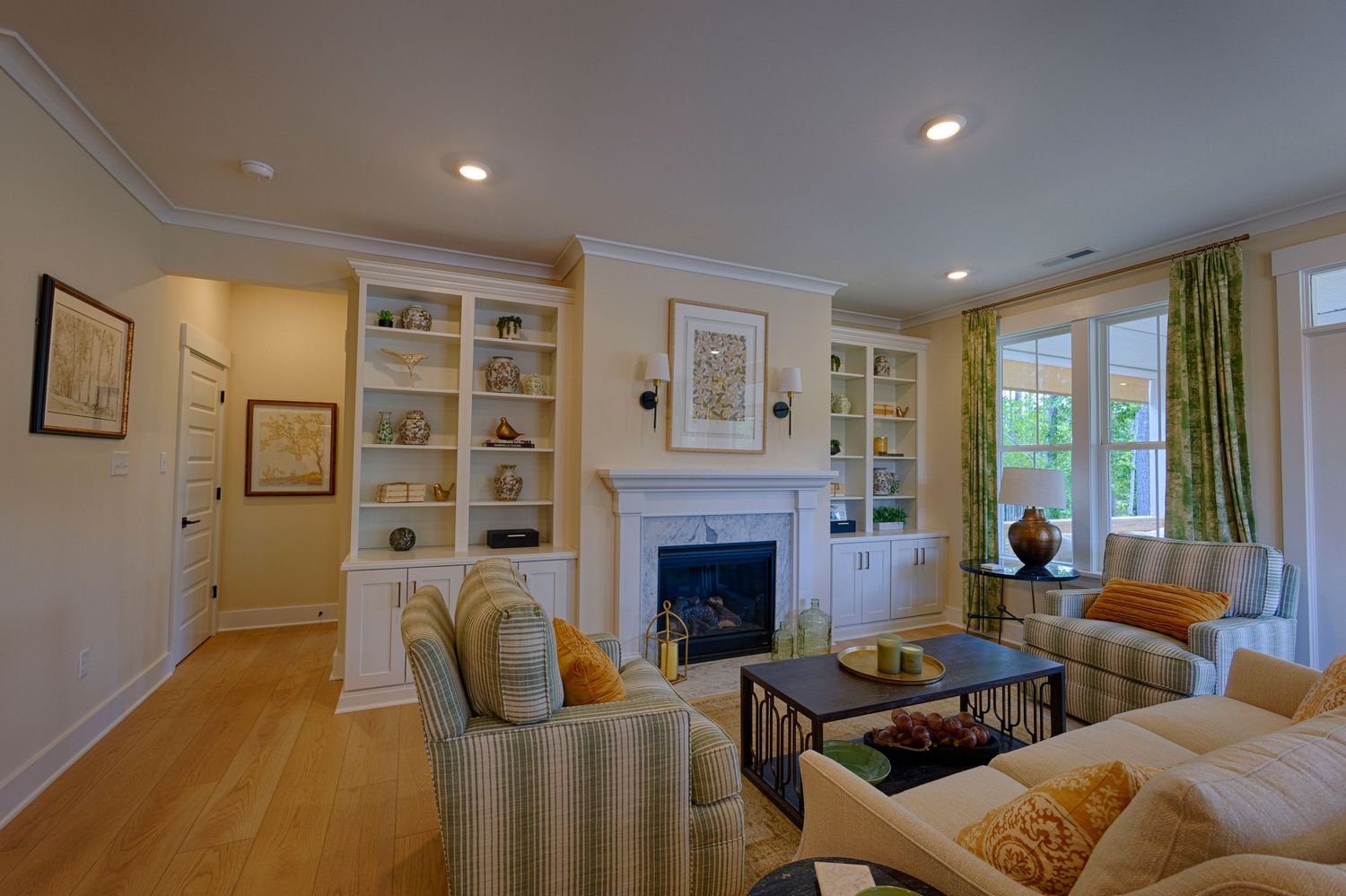 Elegant living room with built-in shelves, fireplace, crown molding, and natural light.Richmond, Virginia.