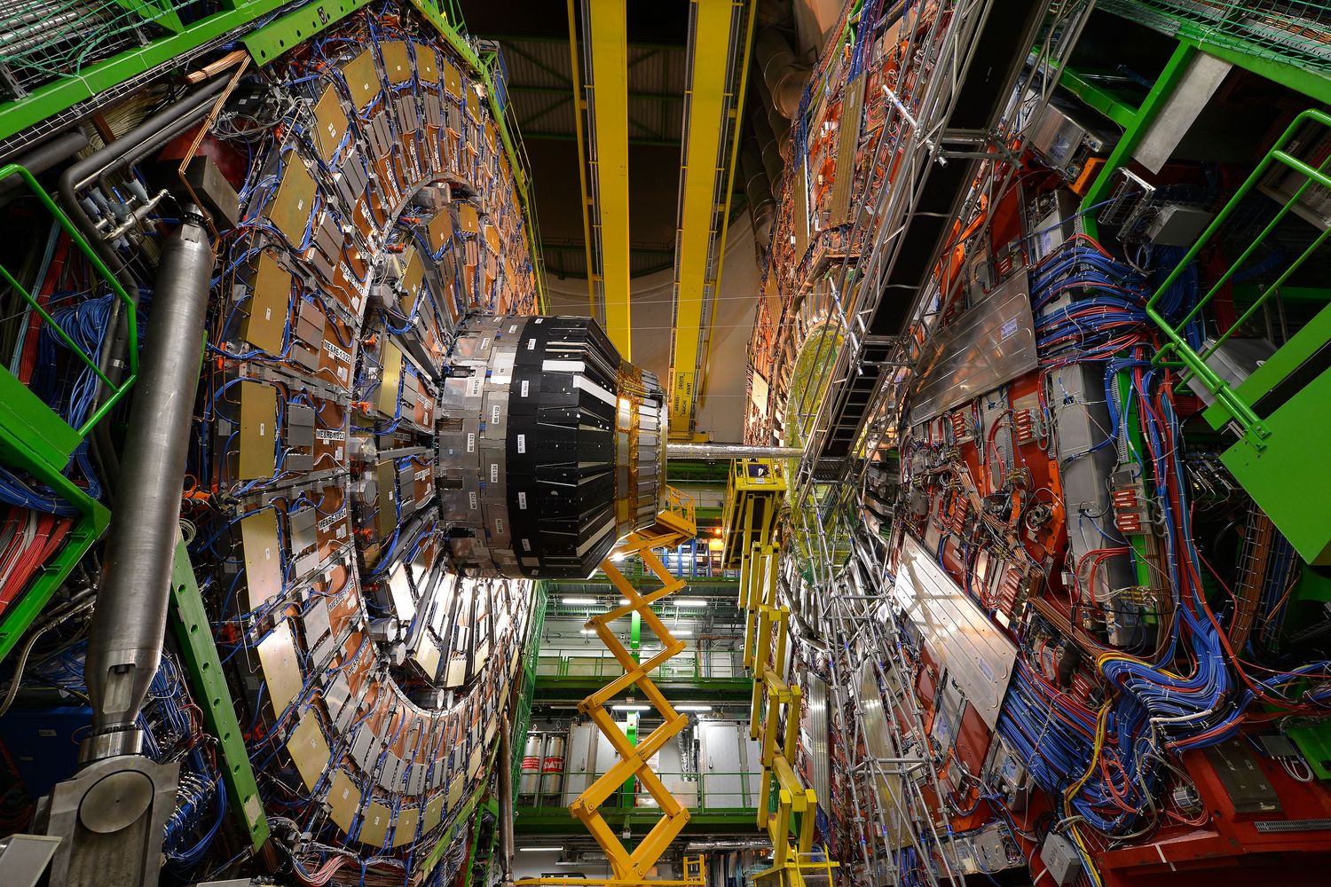 Interior view of the Large Hadron Collider at CERN showing complex machinery and colorful cables.