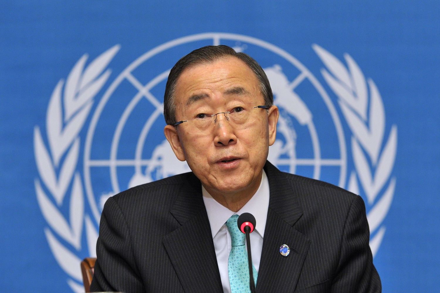 Ban Ki-moon speaks at a podium with the United Nations emblem displayed prominently behind him.