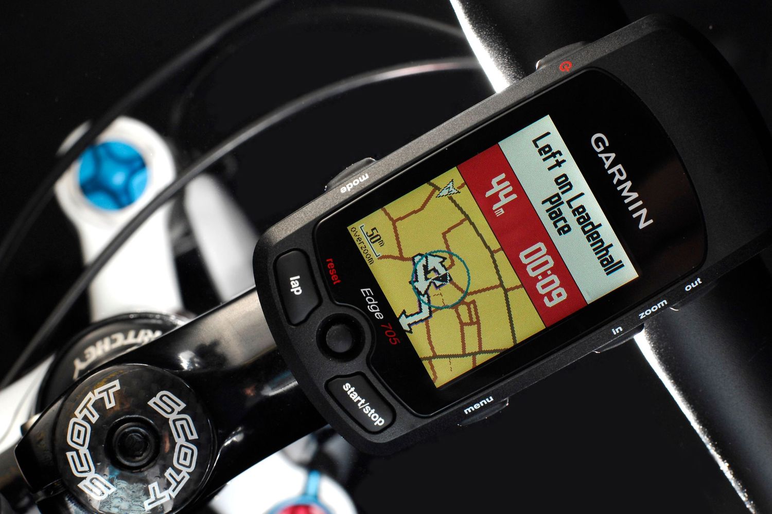 Garmin GPS cycling computer mounted on bike handlebars displaying a map navigation route.
