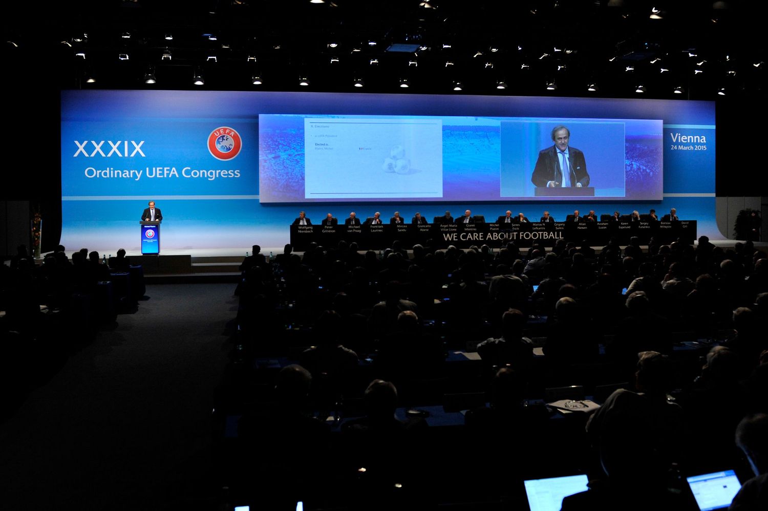 XXXIX Ordinary UEFA Congress conference hall with speaker on stage addressing large audience.
