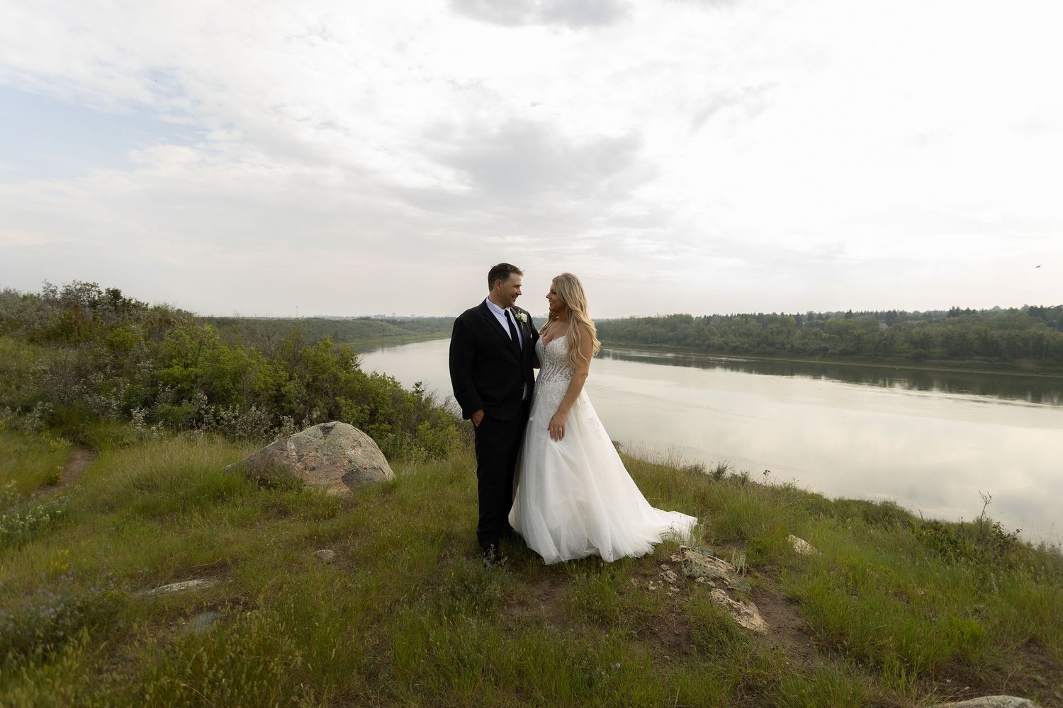 Scenic riverside landscape provides natural backdrop for wedding photography.