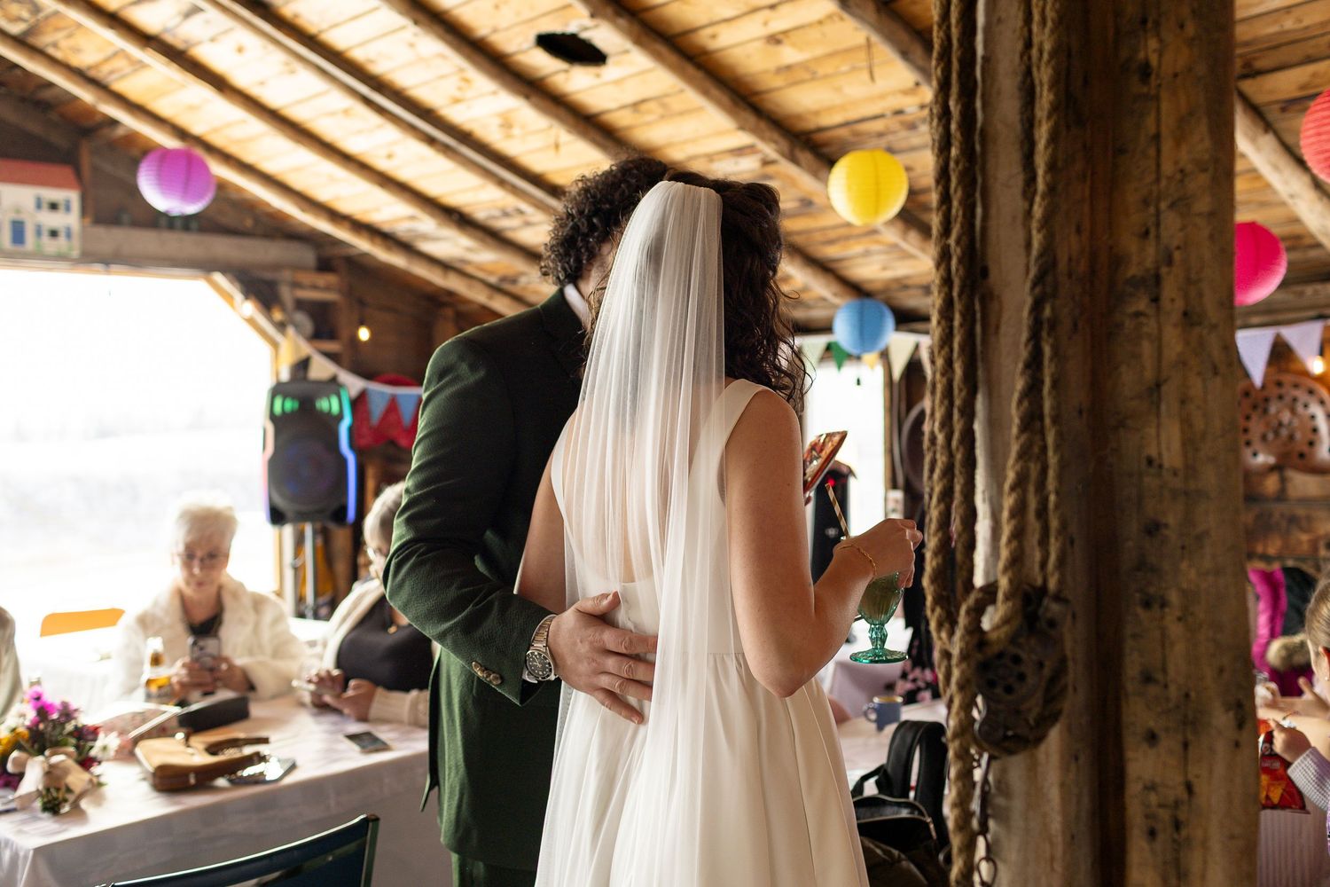 Rustic wooden beams and colorful balloons decorate a barn wedding venue at Grandma's House in Langham, Saskatchewan.