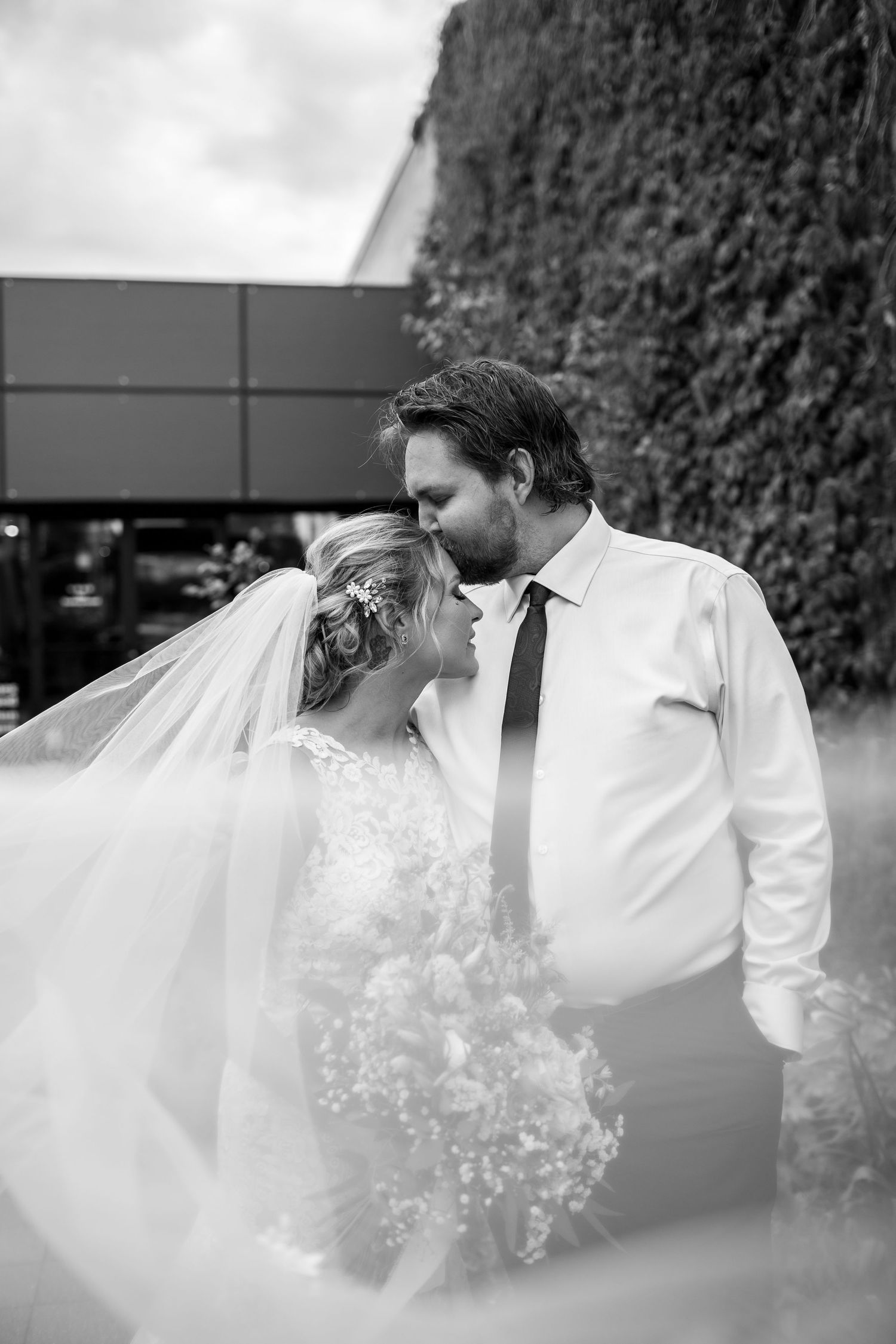 An artistic black and white wedding portrait with flowing veil details at Glass and Lumber in Saskatoon on 20th.