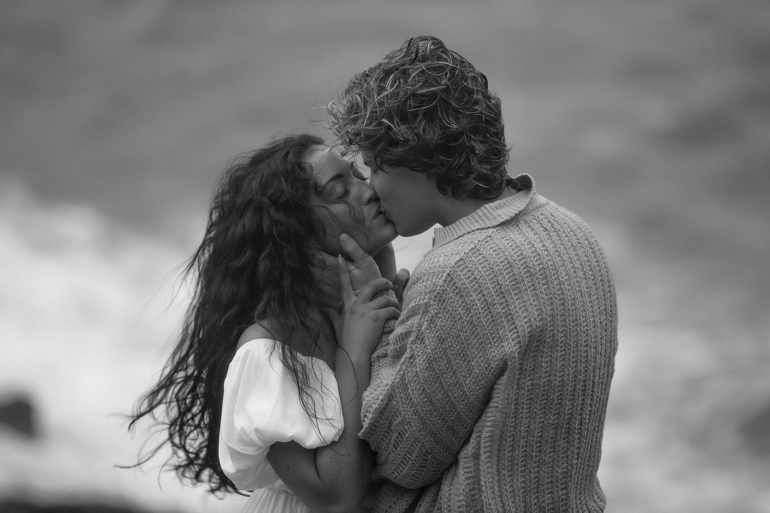 Intimate black and white portrait of a couple sharing a tender moment.