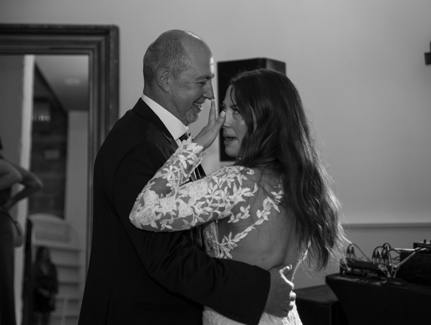 An intimate black and white photograph capturing a tender moment during a wedding dance at the Avenue Room in Saskatoon, Saskatchewan.