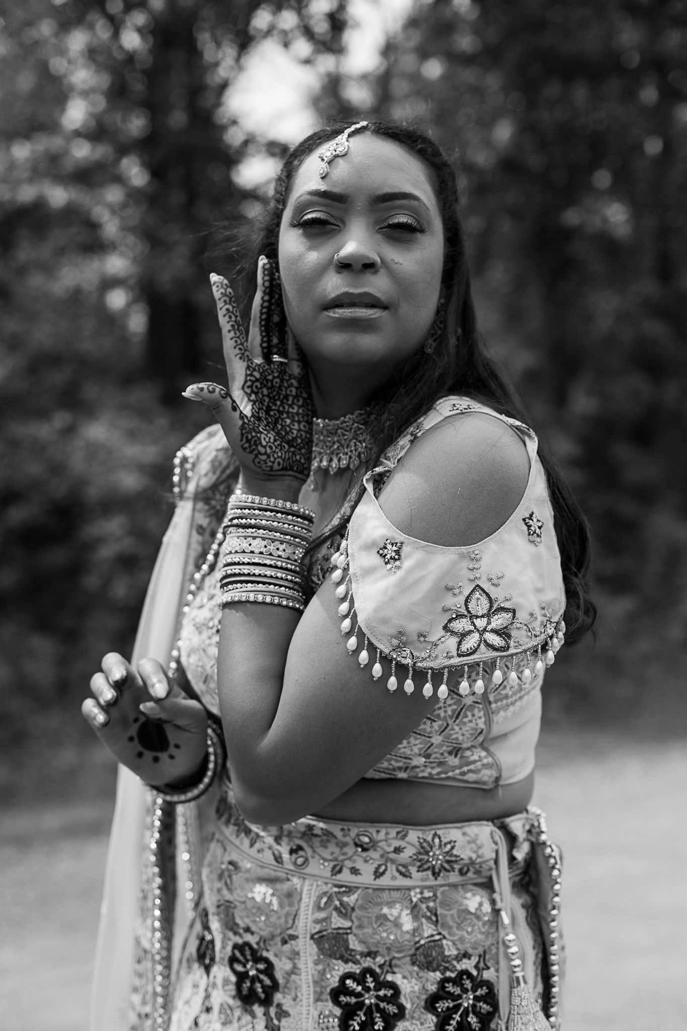 Traditional Indian bridal jewelry and attire details shown in black and white.