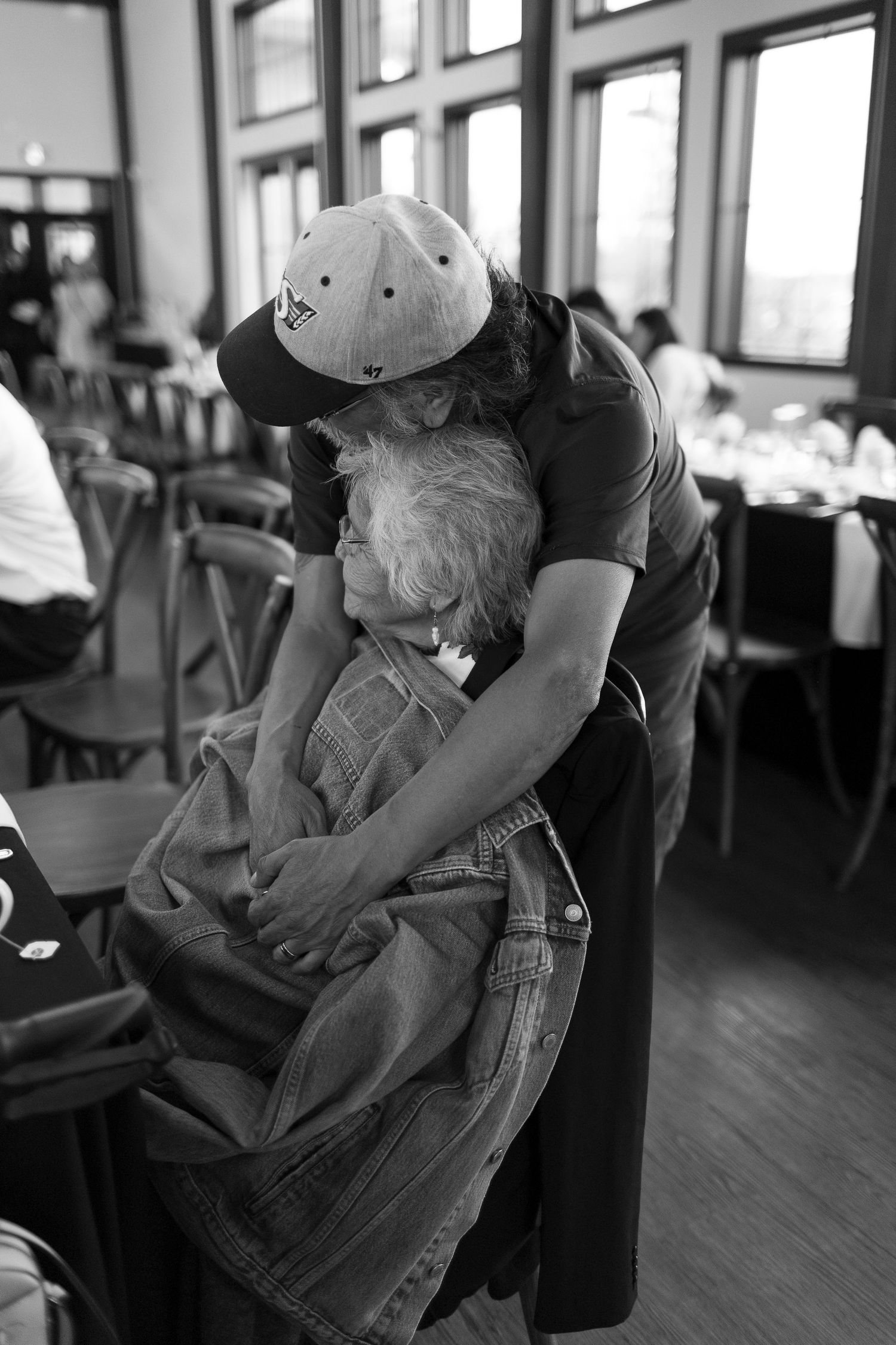 A black and white photo series shows two dancers performing an intimate dance sequence on a wooden floor.