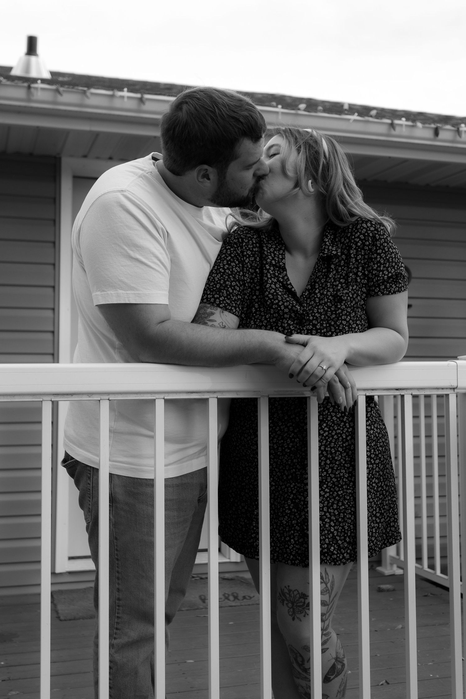 A romantic black and white series of moments shared on a porch railing.