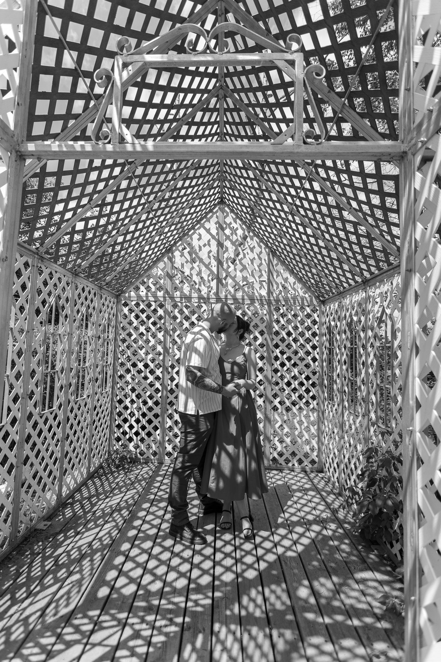 Black and white photos inside a geometric lattice tunnel creating dramatic shadows and patterns at the Berry Barn in Saskatoon, Sask.