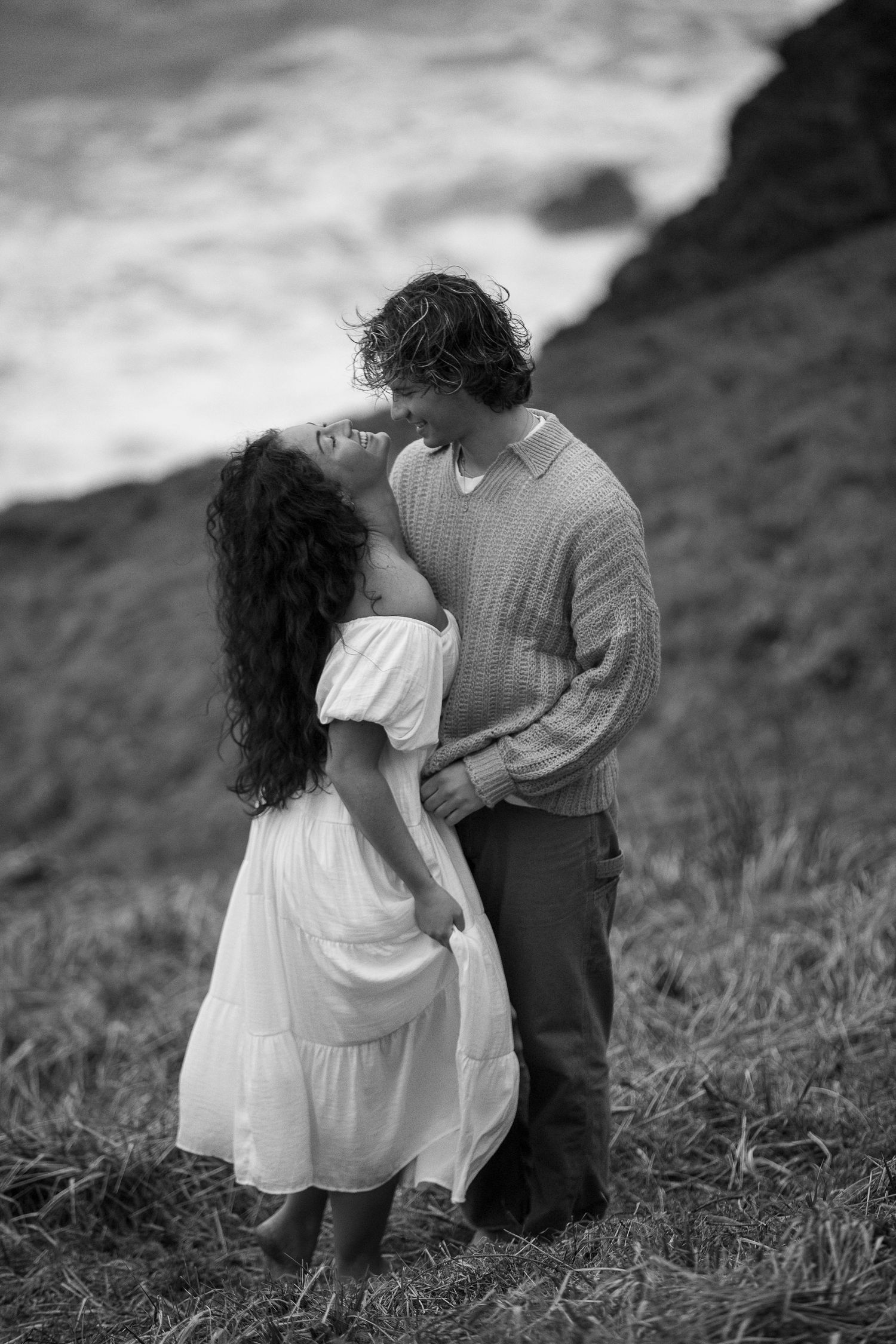 Series of black and white romantic photos showing a couple in an intimate moment on a hillside.