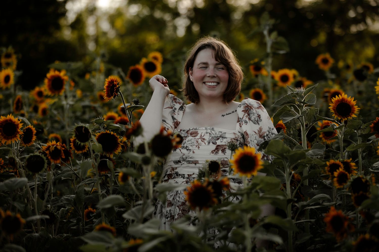 Joyful moment captured in a blooming sunflower garden during golden hour.