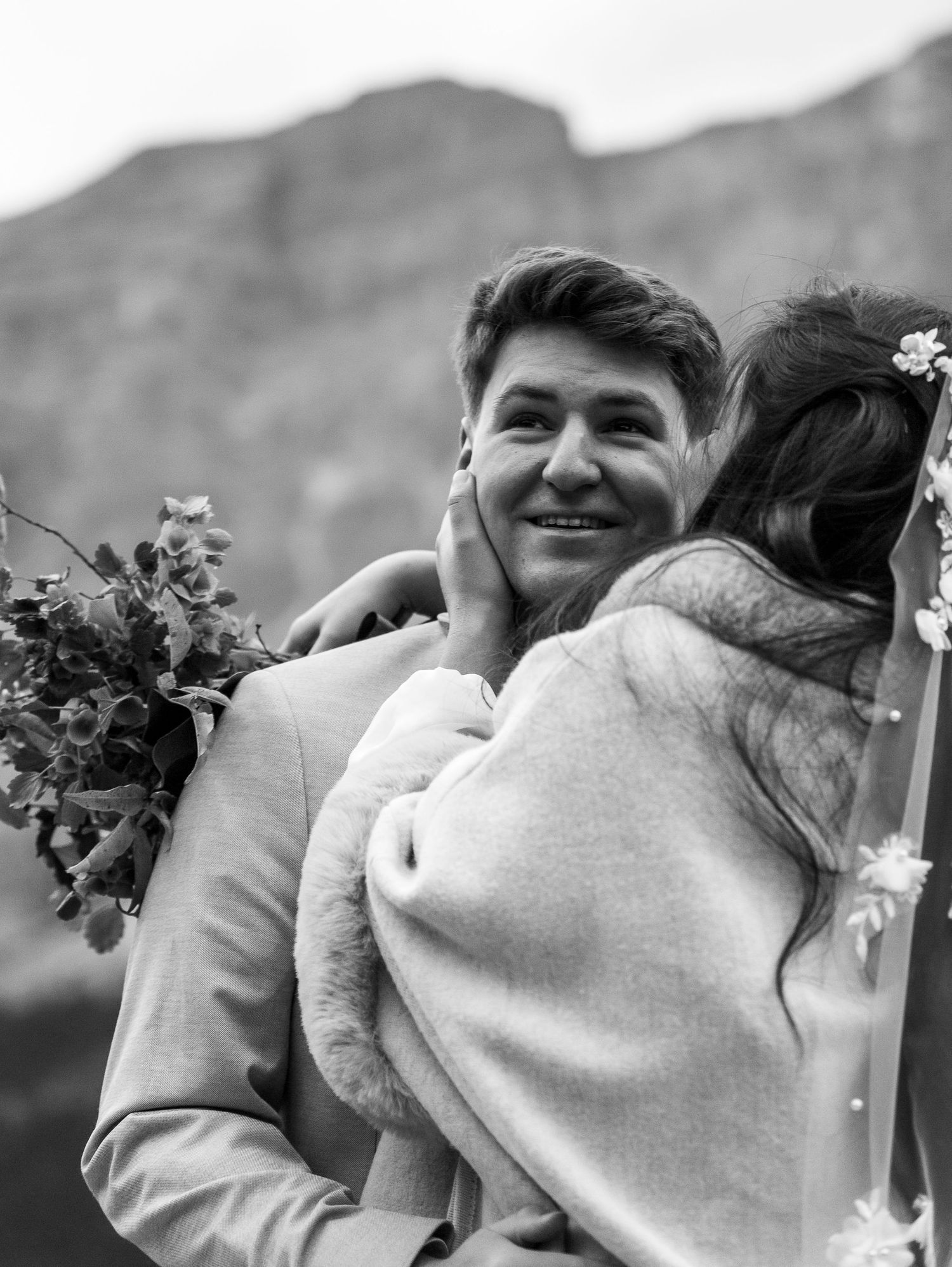 Intimate wedding couple moment captured in black and white against a mountain backdrop at Banff National Park on the Canadian Rockies.