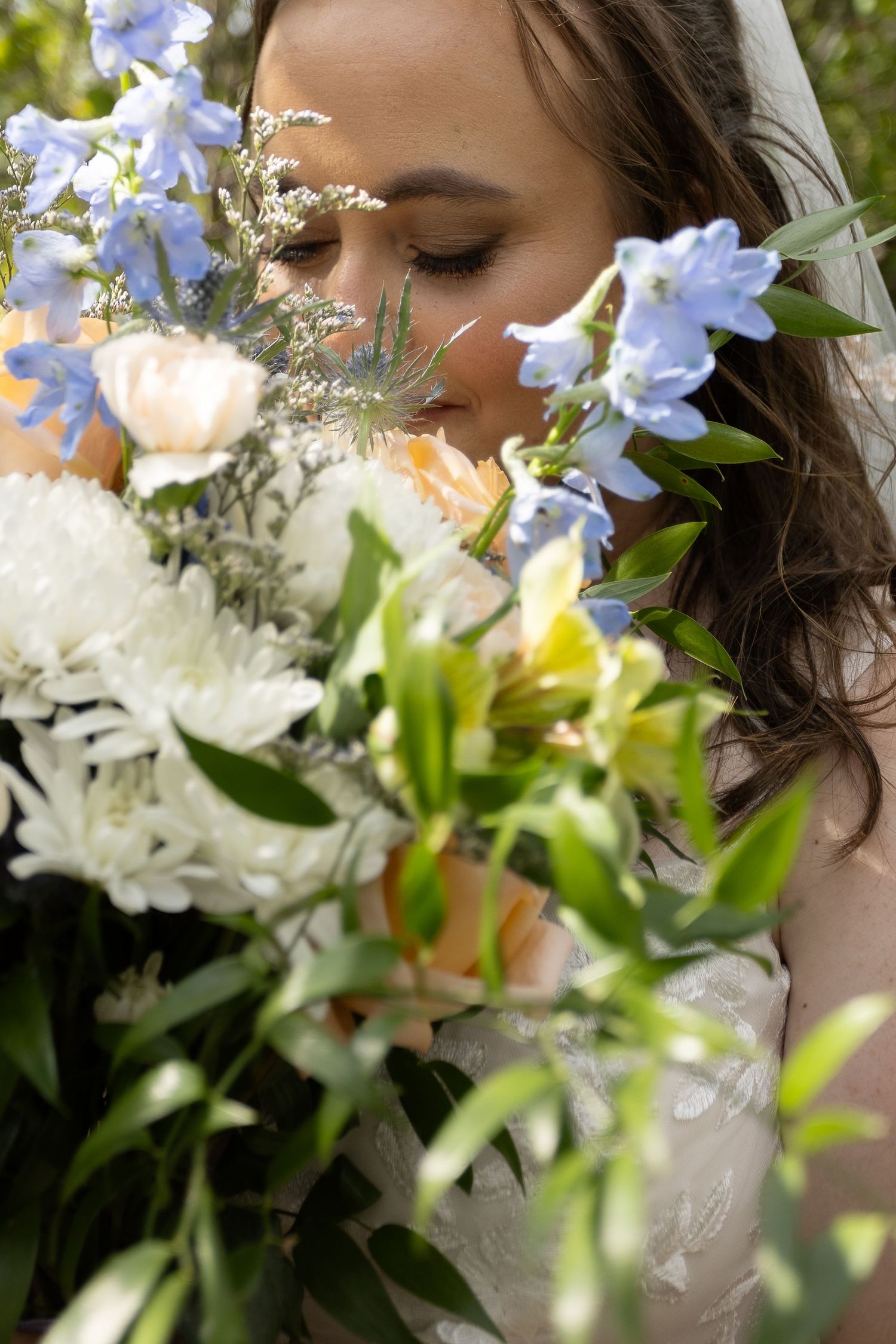 An elegant bridal bouquet featuring white and blue flowers with delicate greenery.