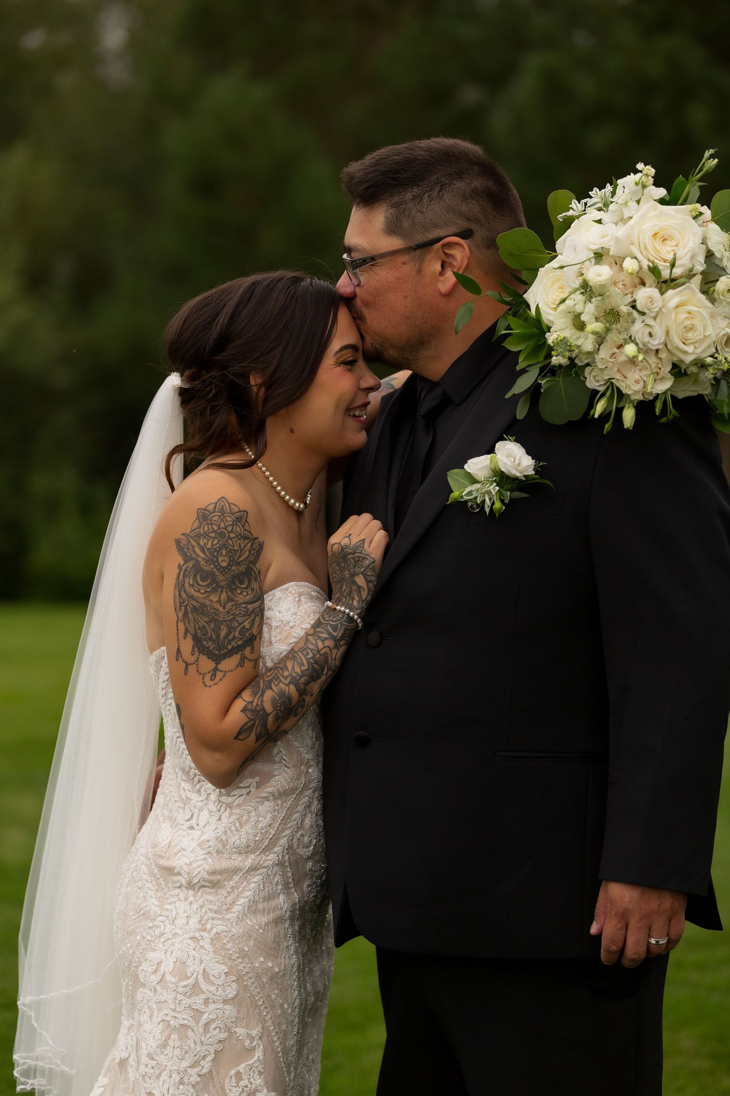 An intimate wedding portrait captured outdoors with a beautiful floral bouquet at Barn at Wind's Edge in Saskatoon, Saskatchewan.