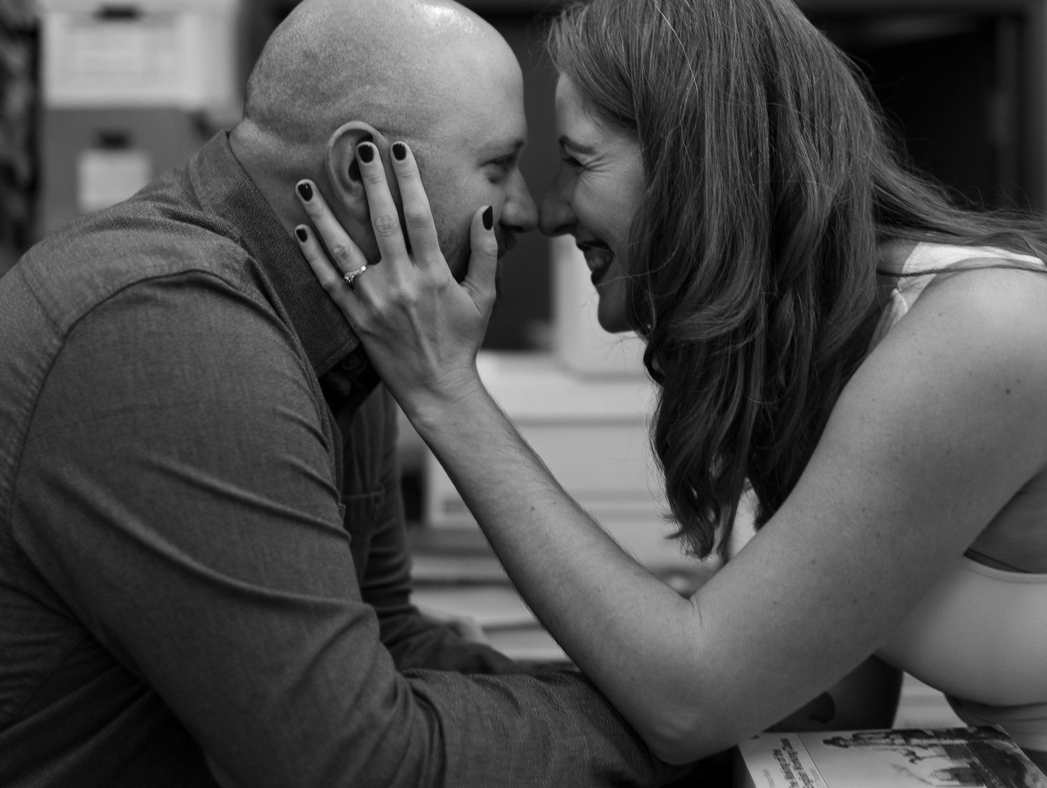 Intimate black and white portrait of a couple sharing a tender moment.