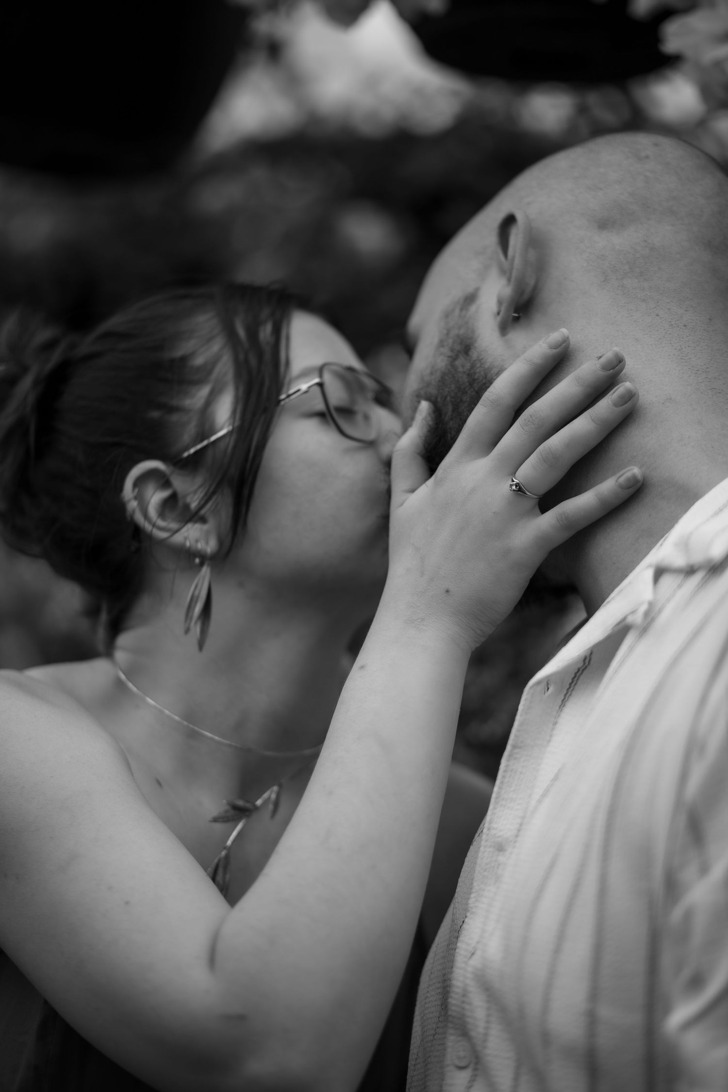 Black and white close-up photo of a tender embrace between two people at the Berry Barn in Saskatoon, Sask.