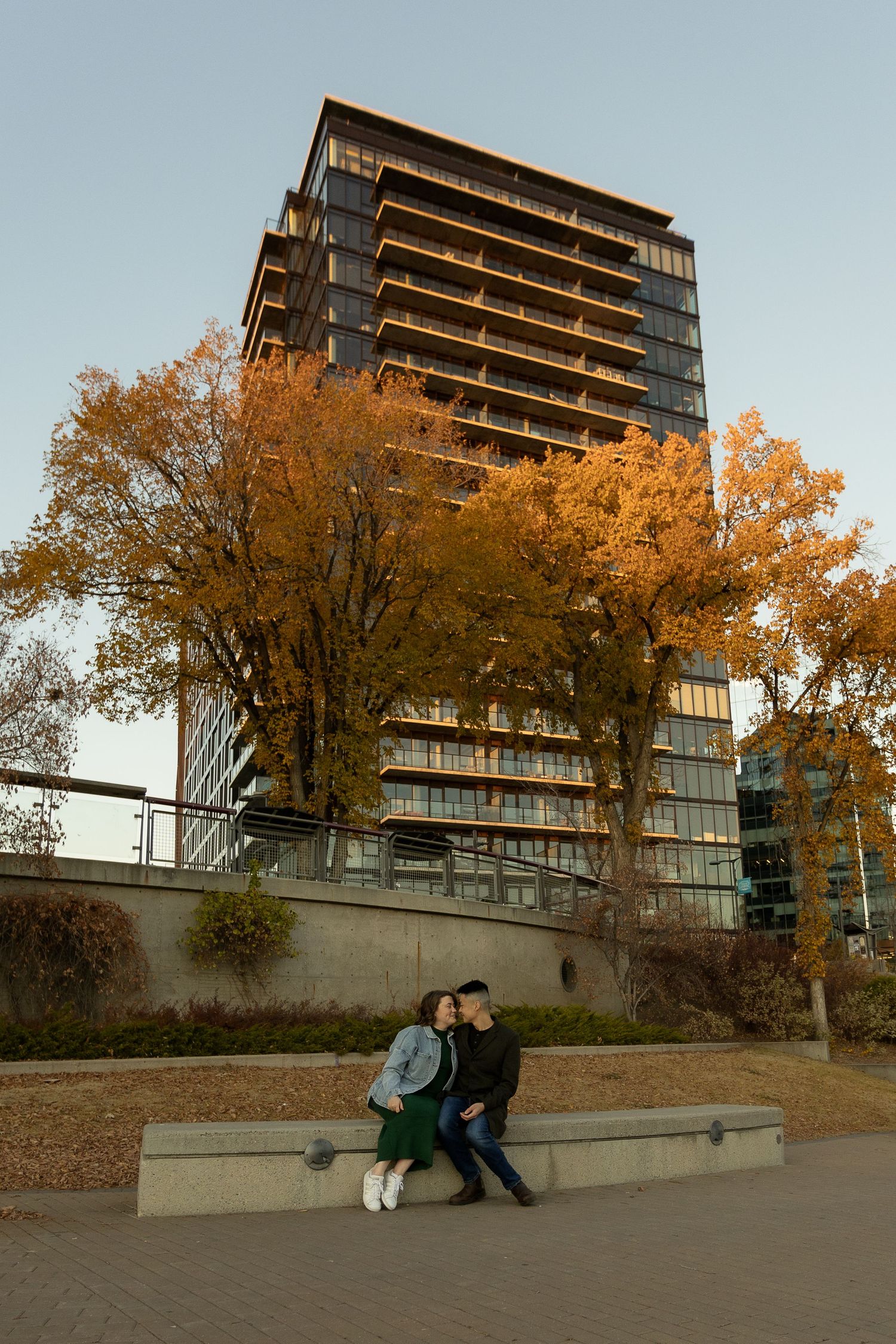 A series of four sequential photos showing people sitting on concrete steps against a backdrop of modern apartment buildings.