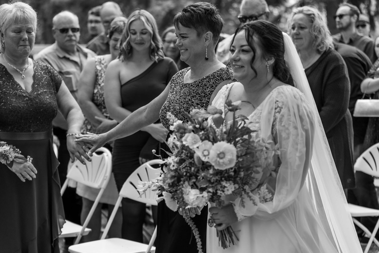 Wedding guests gather outdoors to celebrate during a joyous ceremony.