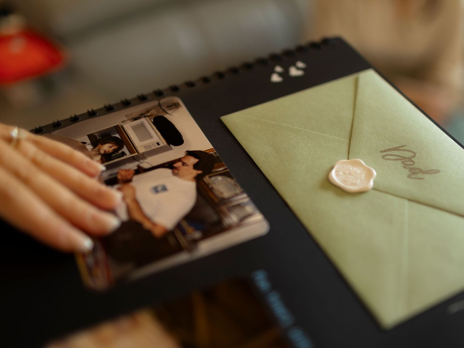 Wedding photo album and envelopes displayed on dark surface.