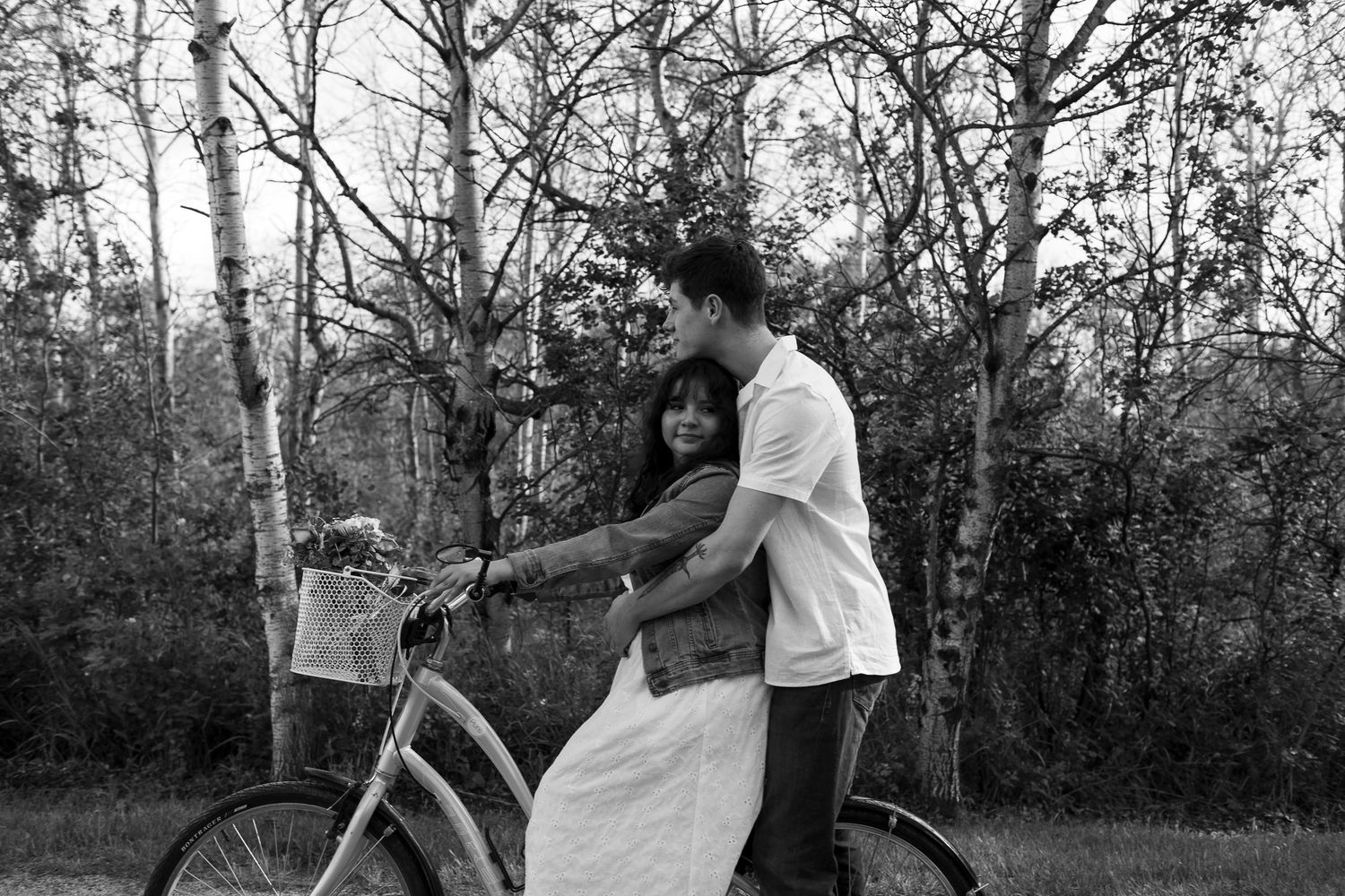 Couple enjoying a romantic moment together on a wooded path at the Lawrence House in Saskatoon, Saskatchewan.