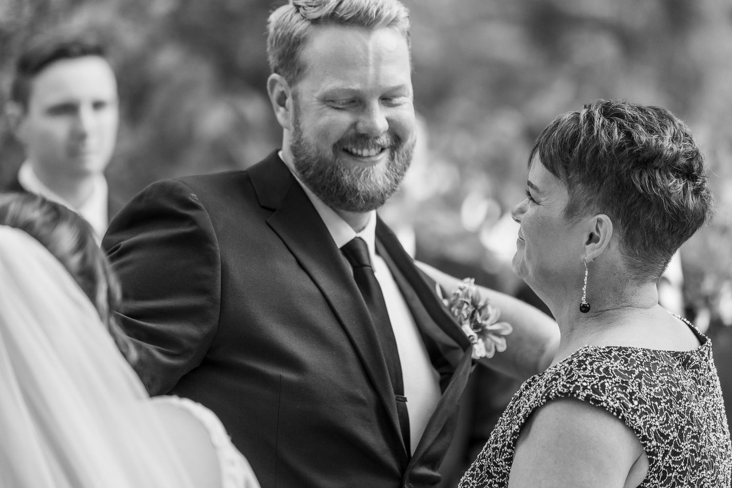 Intimate wedding ceremony moment captured in black and white photography.