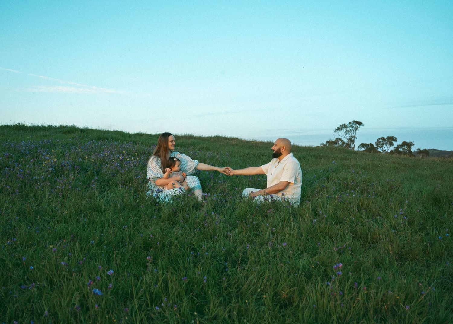 A motherhood family photo shoot at sunset at Mount Osmond with a mother, father and their baby.