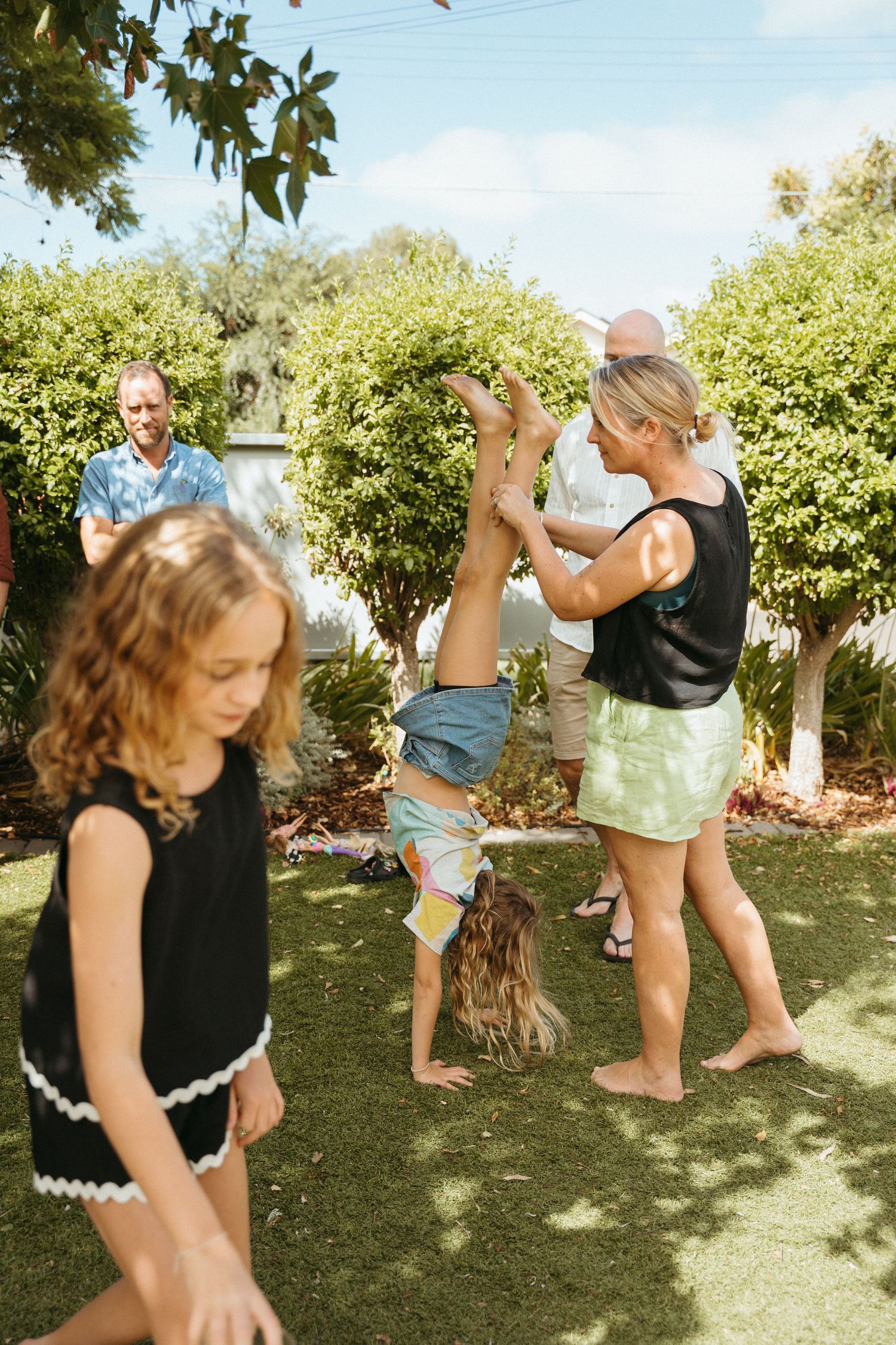 An extended family photoshoot at their family home with the children and grandchildren laughing and having fun together.