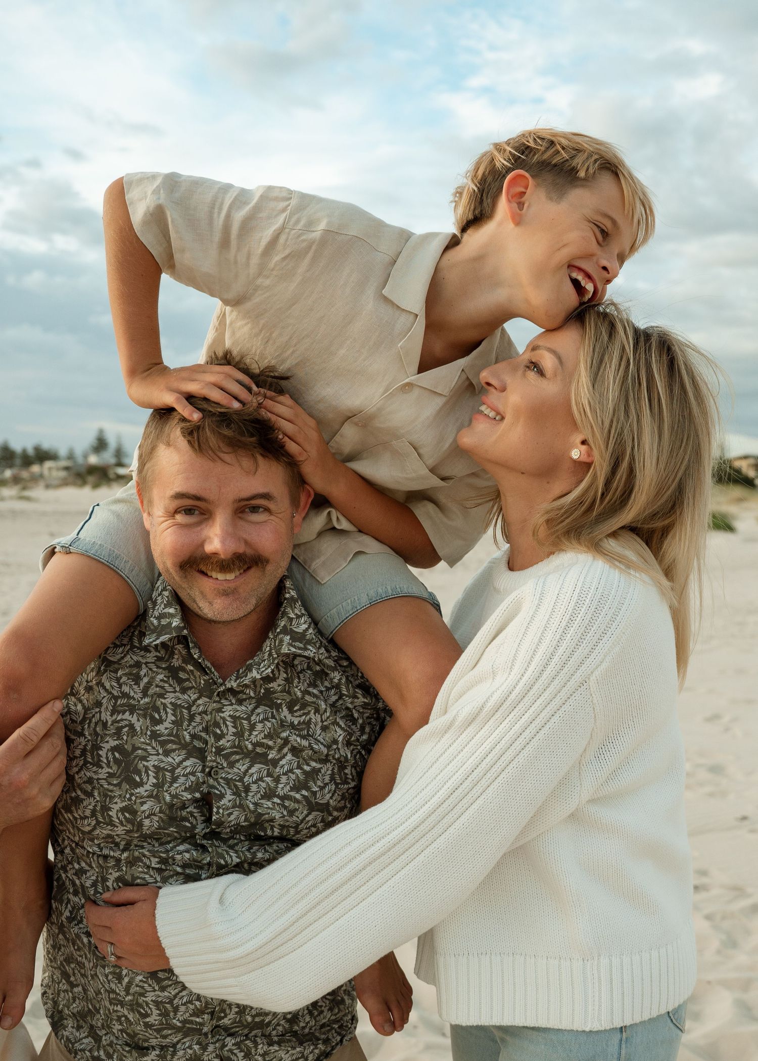 A family photography session at the beach at sunset with their 2 children.