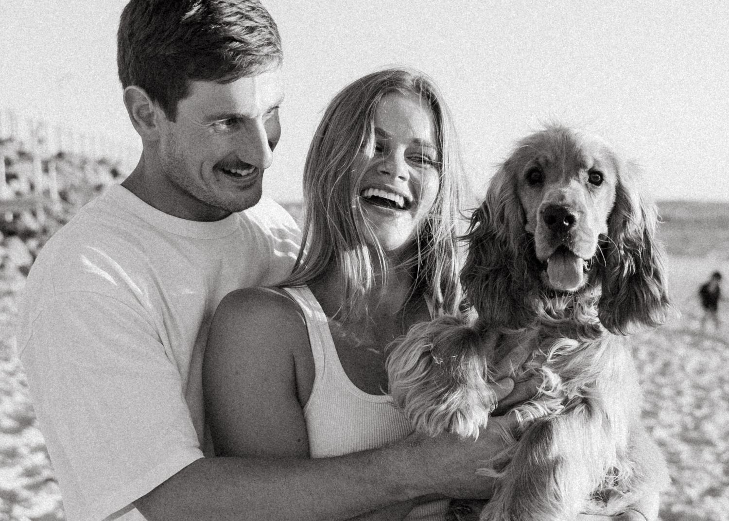 Couple and their dog at a couples photoshoot at an Adelaide beach at sunset, golden hour.